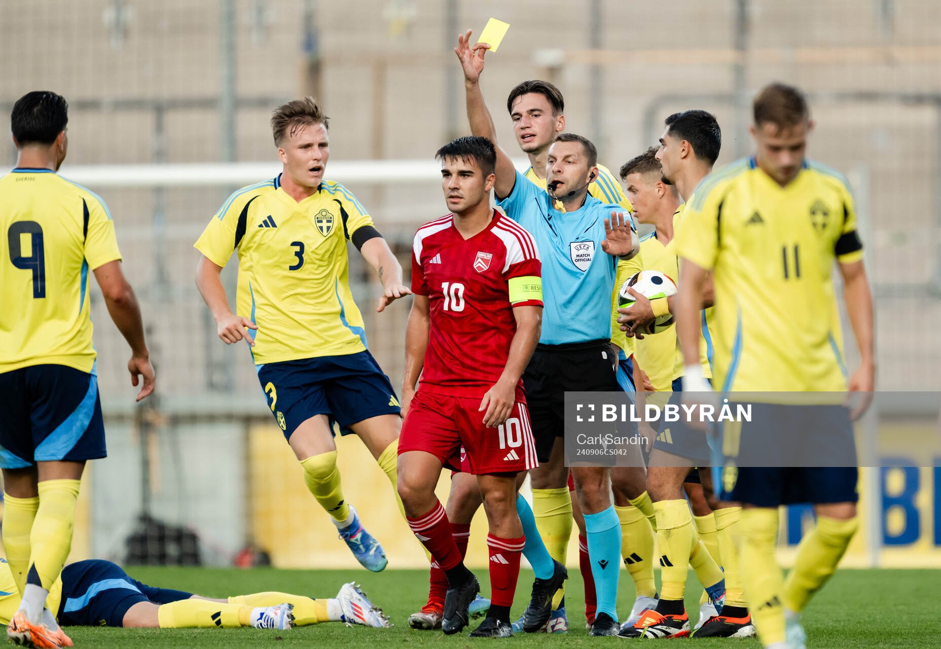 Dylan Borge of Gibraltar receives a yellow card