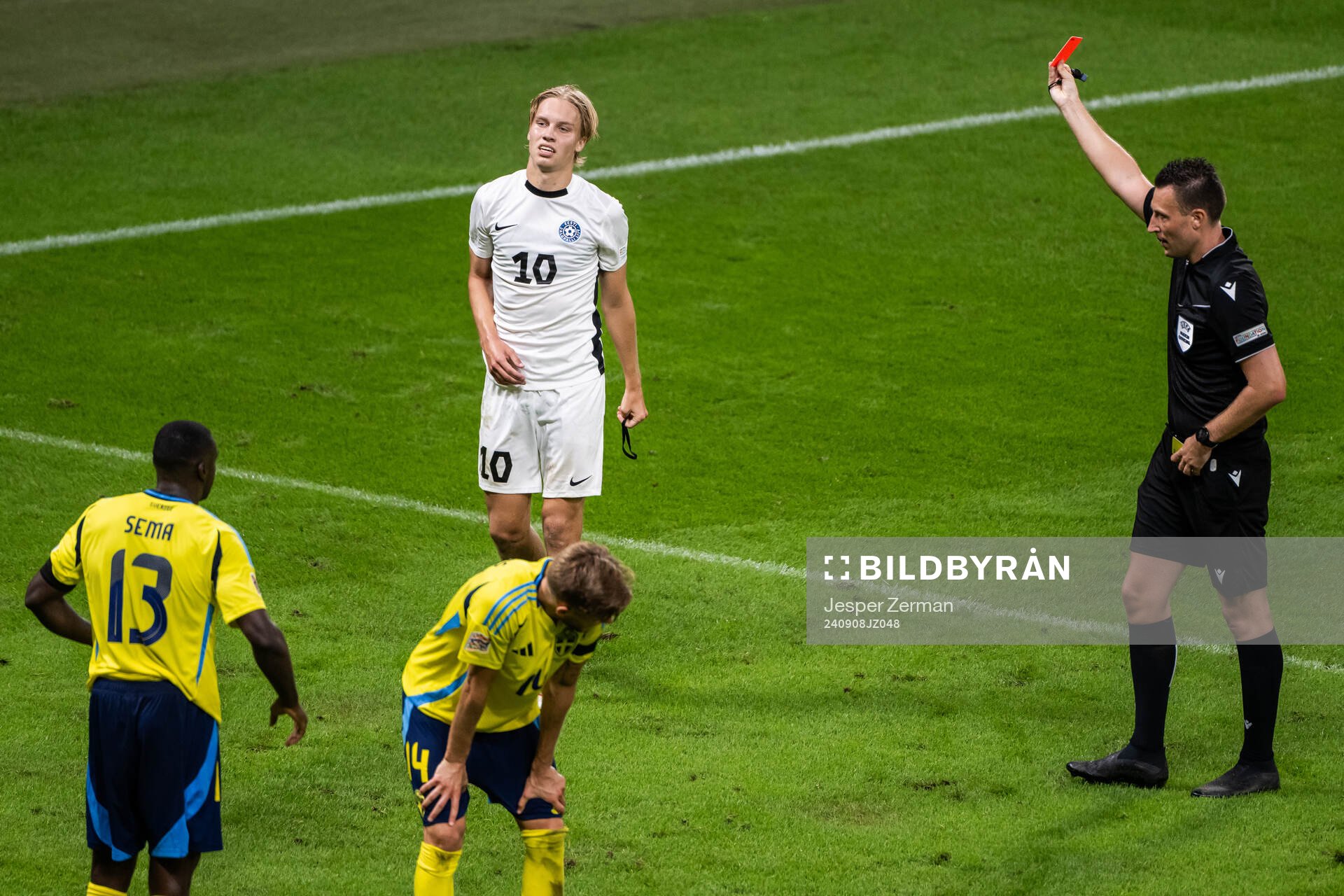 Kevor Palumets of Estonia receives a red card from referee Sven Jablonski during the Nations League football match between Sweden and Estonia on September 8, 2024 in Stockholm.