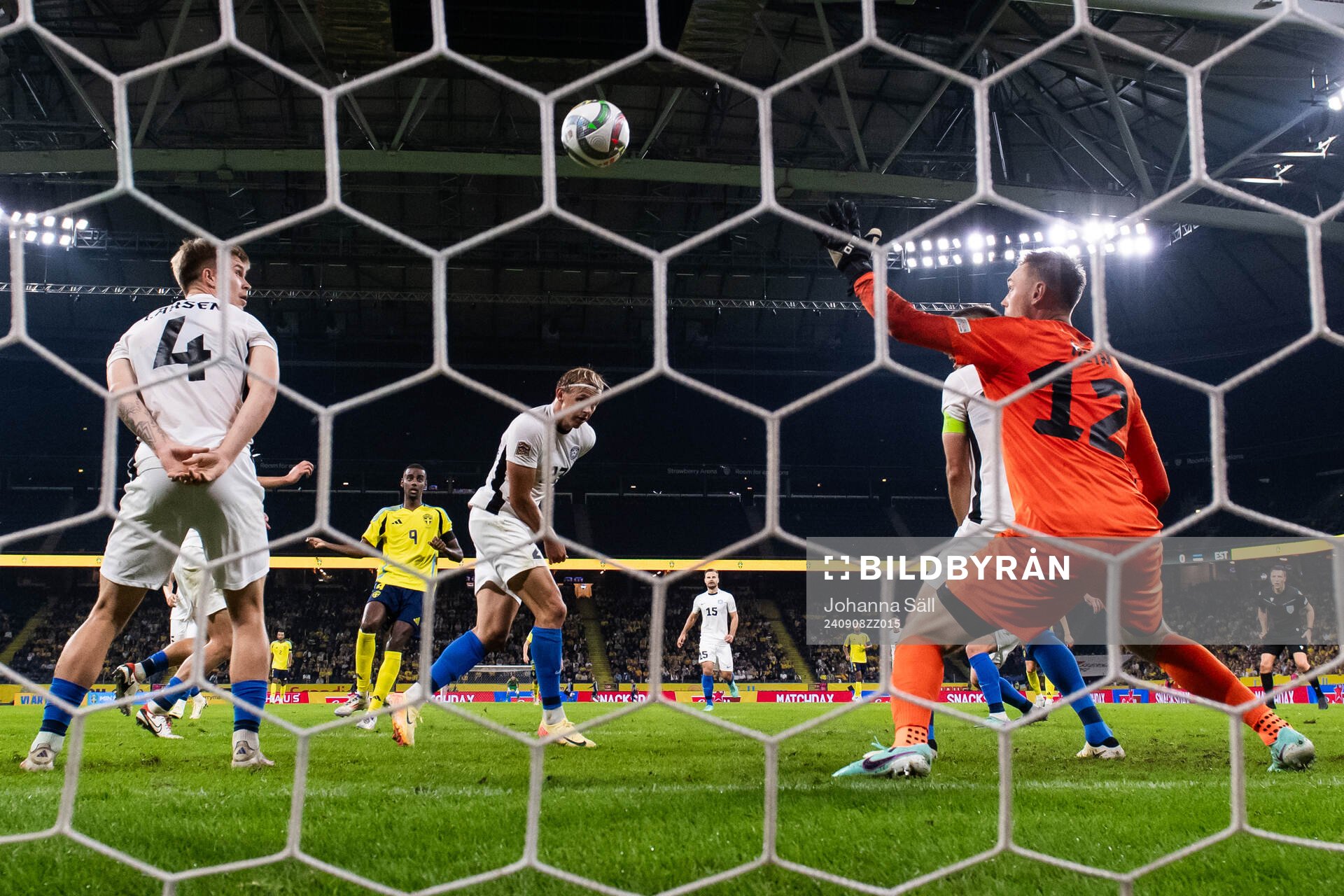 Alexander Isak of Sweden scores 2-0 behind goalkeeper Karl