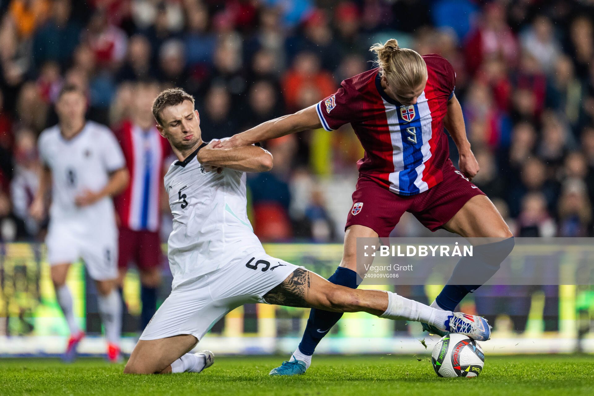 Stefan Posch of Austria and Erling Braut Haaland of Norway