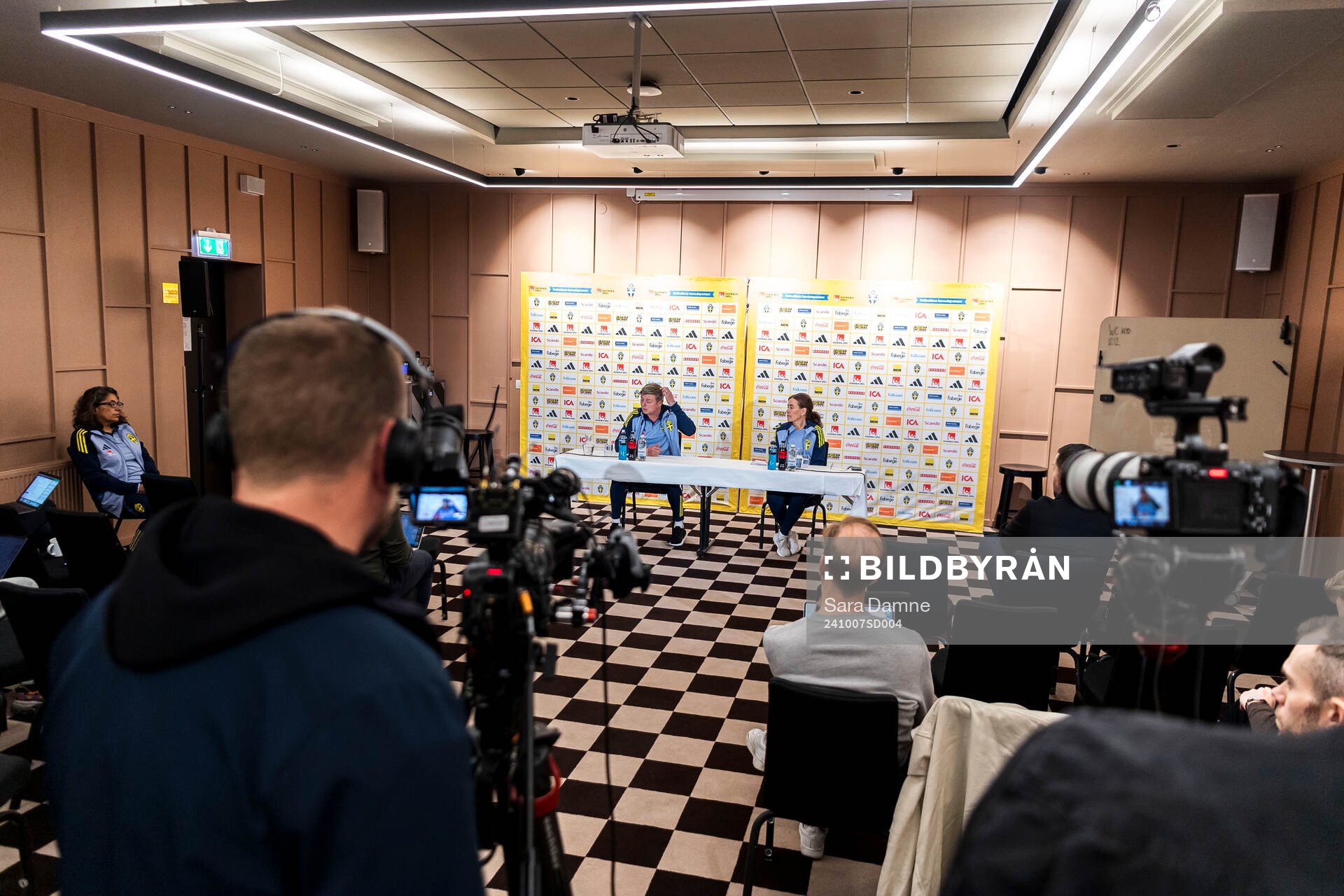 Head coach Jon Dahl Tomasson and media officer Petra