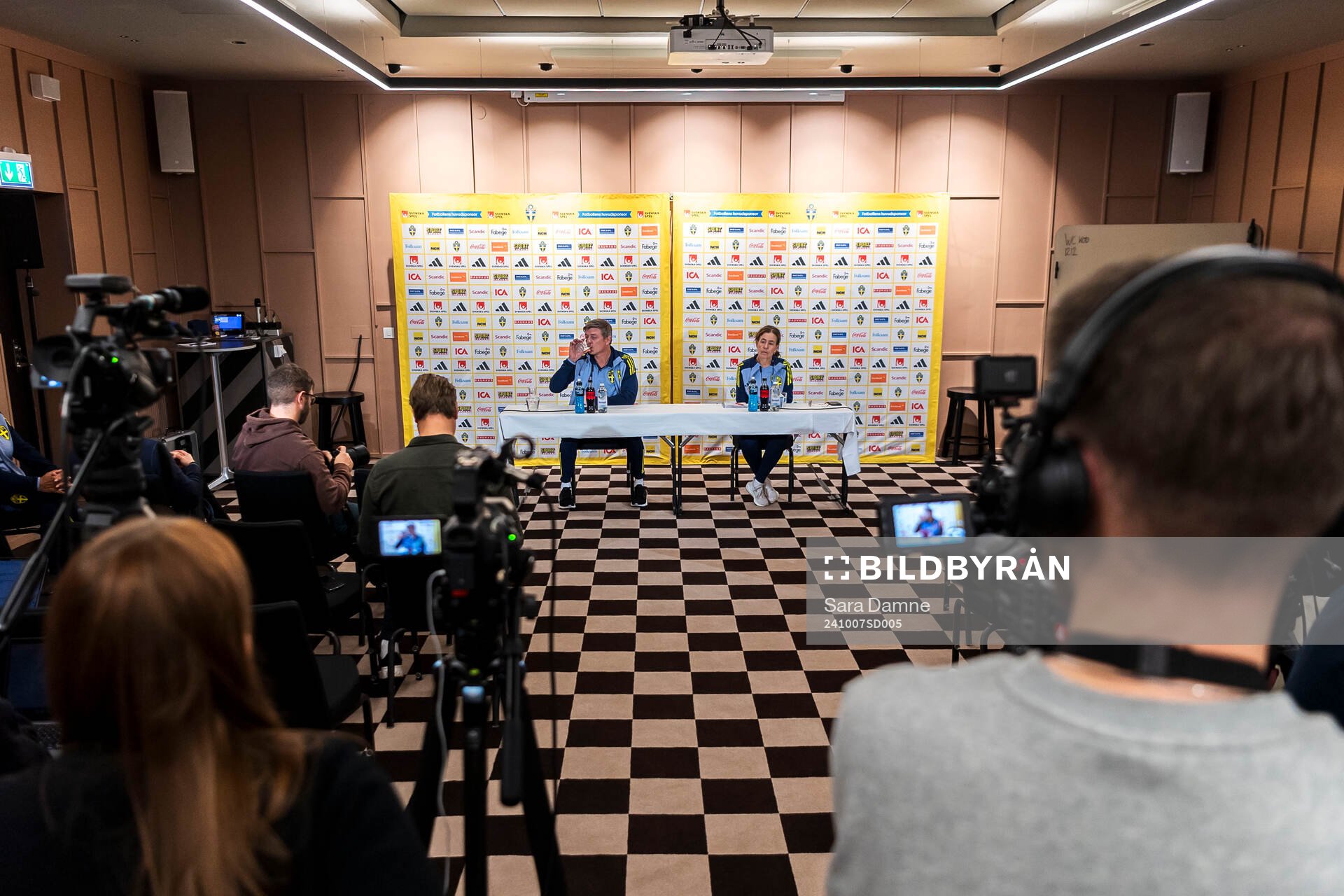 Head coach Jon Dahl Tomasson and media officer Petra