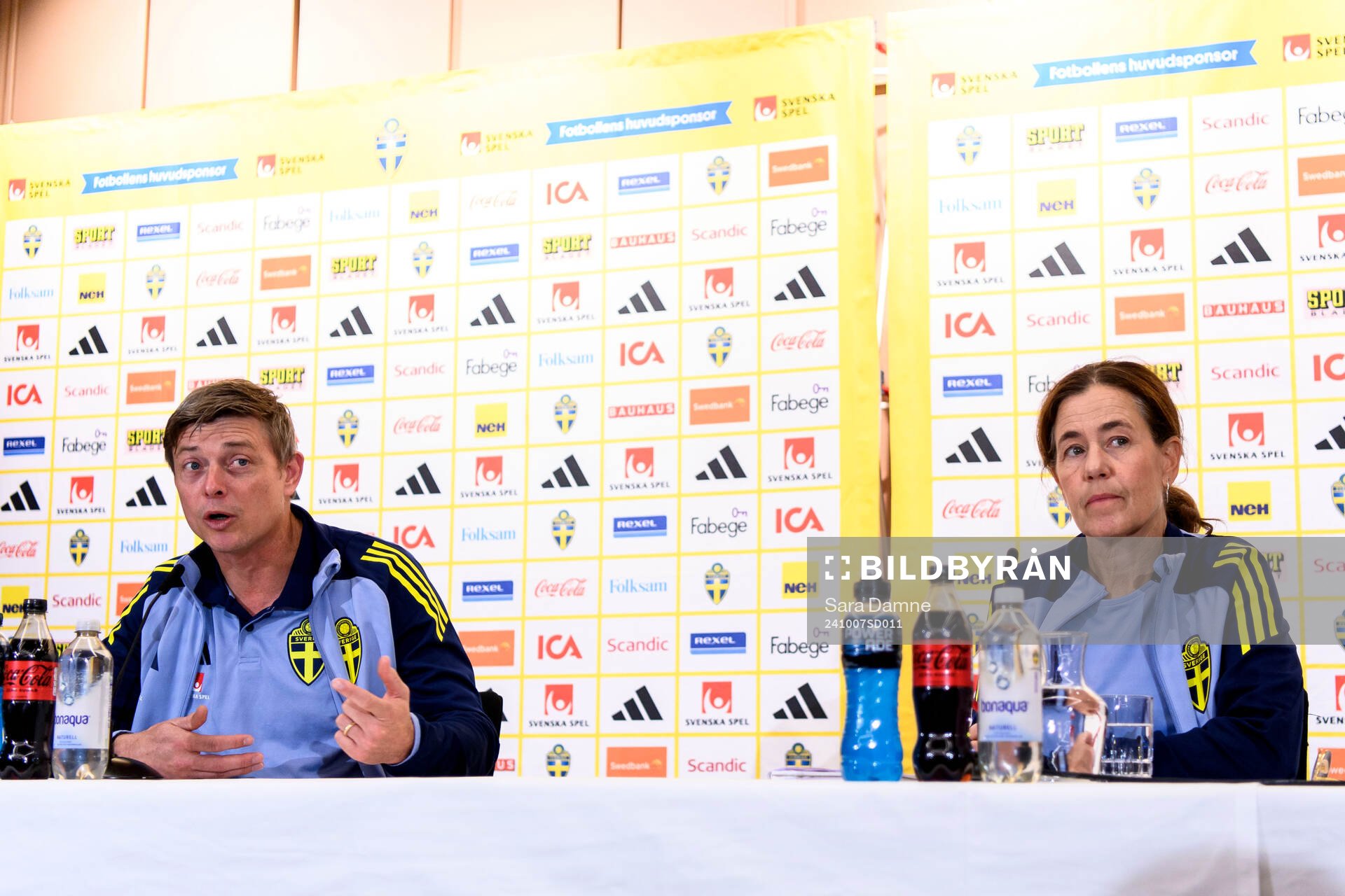 Head coach Jon Dahl Tomasson and media officer Petra