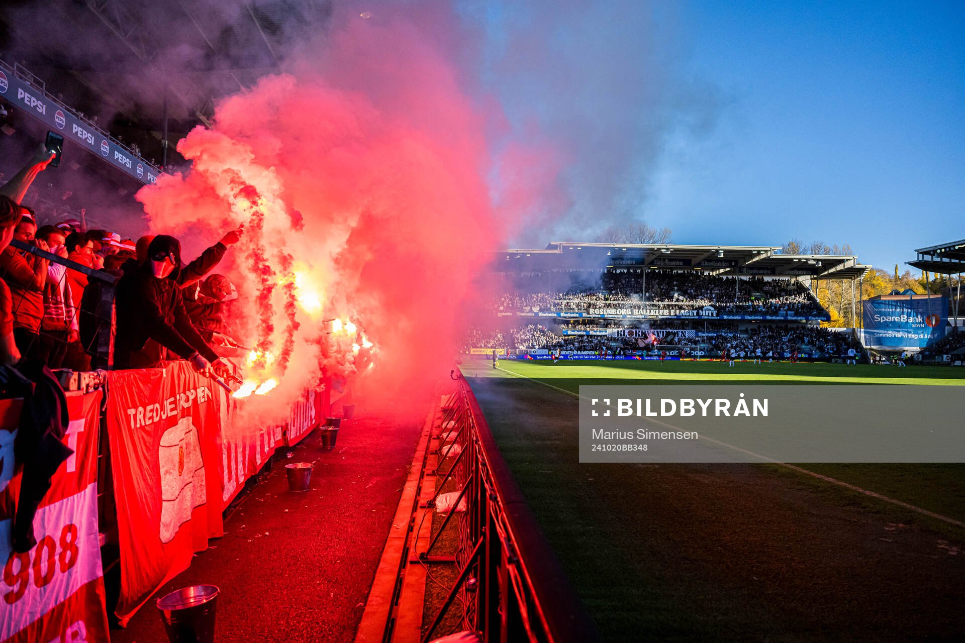 Spectators in the stands with flares during the Eliteserien match between Rosenborg and Brann on October 20, 2024 in Trondheim. 