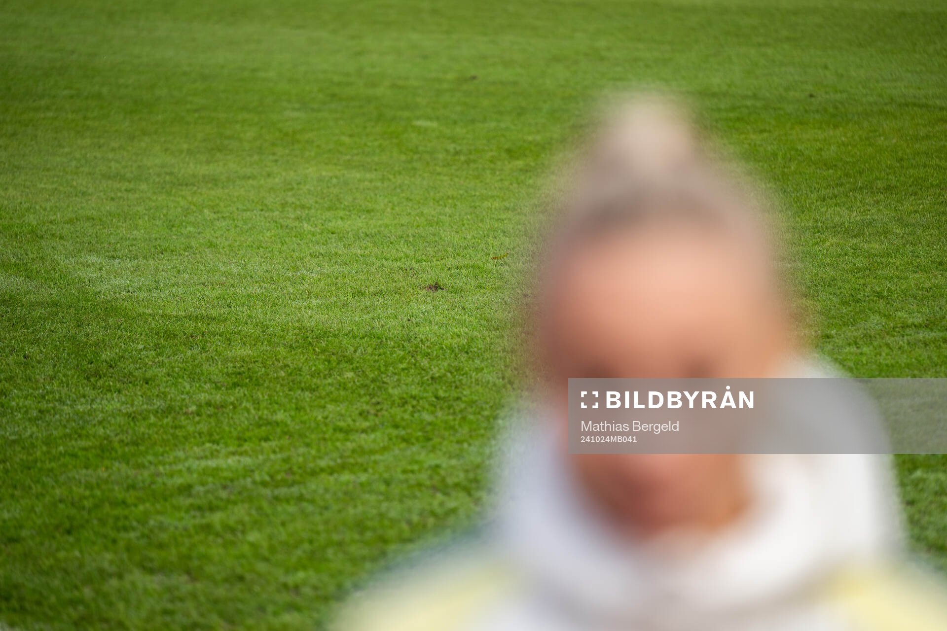 The grass of the pitch is seen behind Fridolina Rolfö of