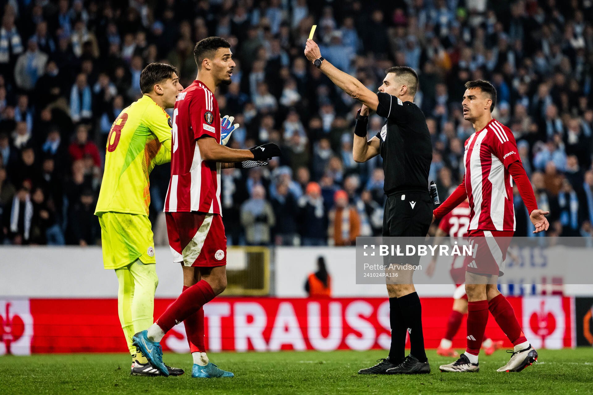 Goalkeeper Kostas Tzolakis of Olympiacos receives a yellow