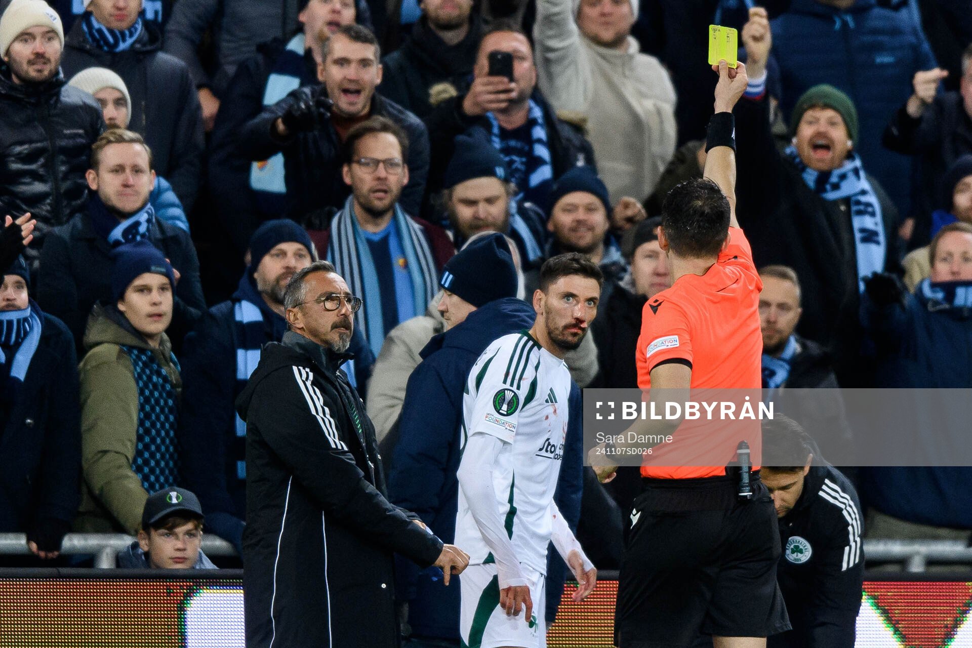 Filip Mladenovic of Panathinaikos receives a yellow card