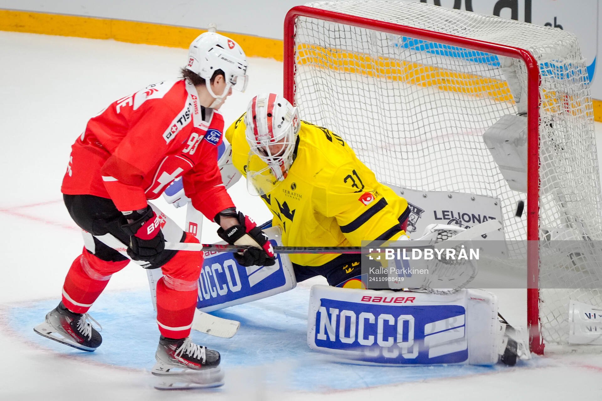 Theo Rochette of Switzerland and goaltender Jacob Johansson