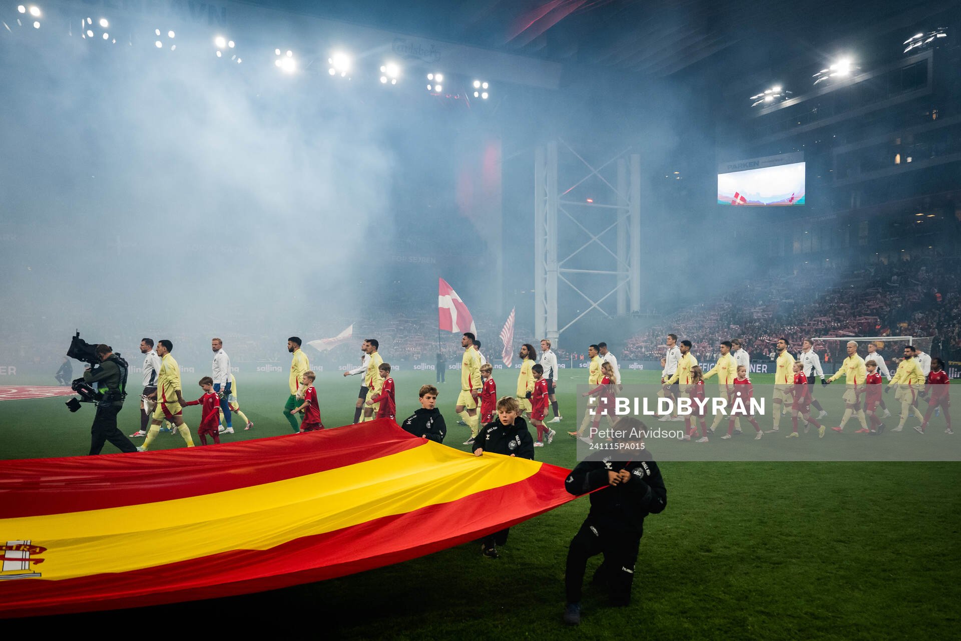 Players of Spain and Denmark enter the pitch