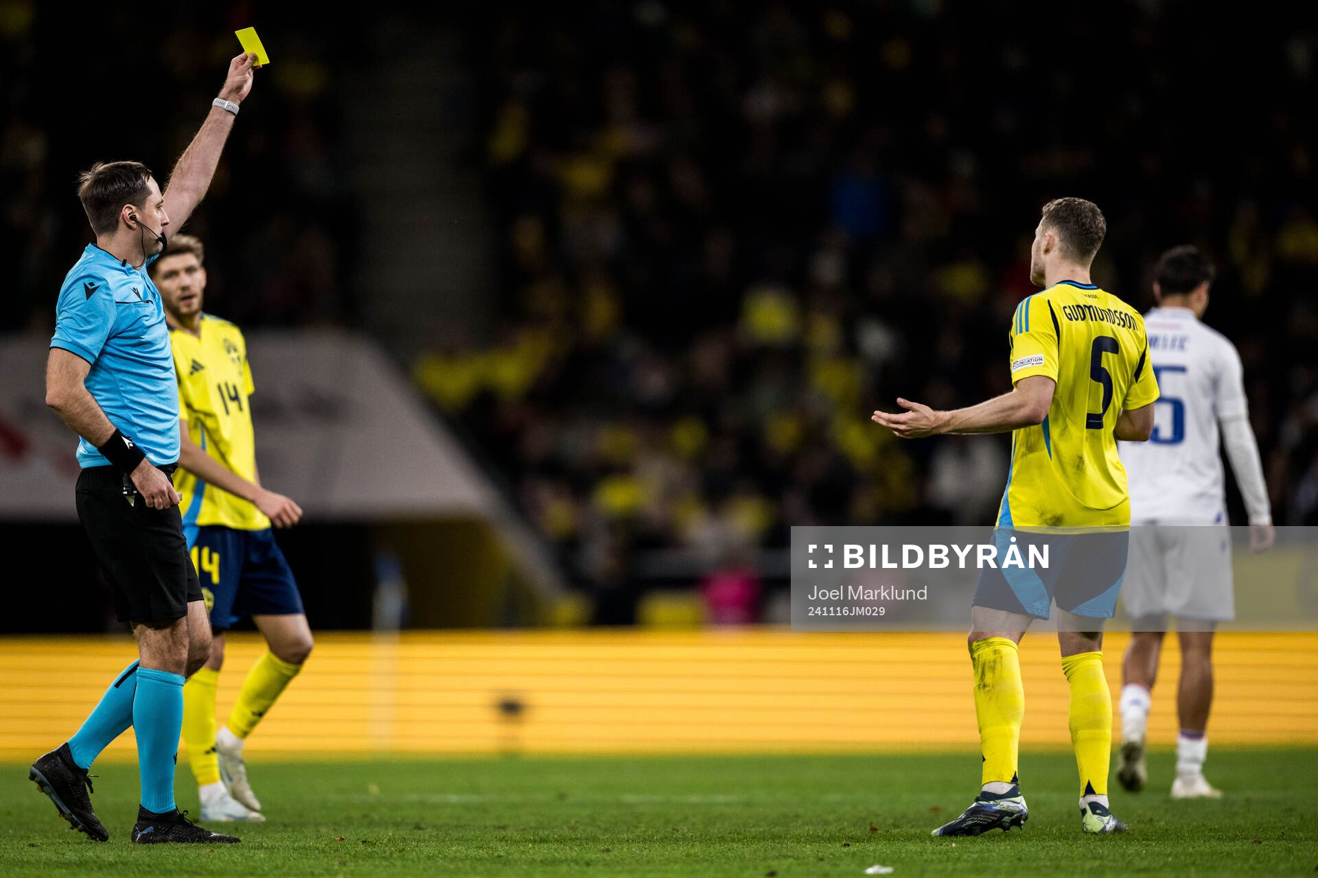 Gabriel Gudmundsson of Sweden revives a yellow card
