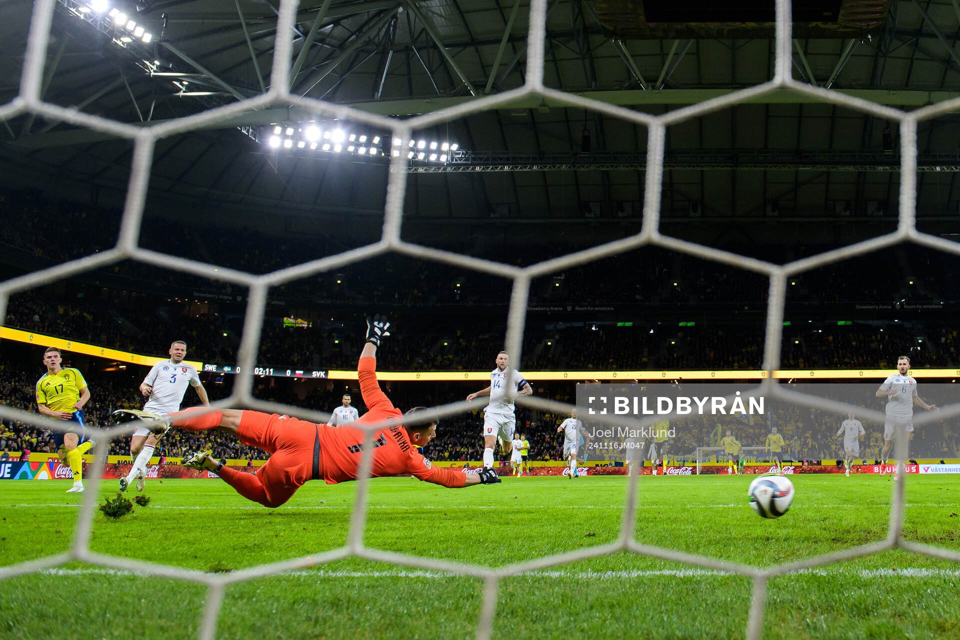 Viktor Gyökeres of Sweden scores 1-0 behind goalkeeper