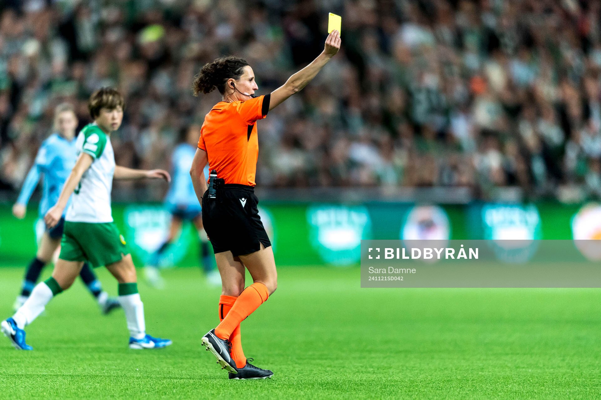 Referee Silvia Gasperotti shows a yellow card
