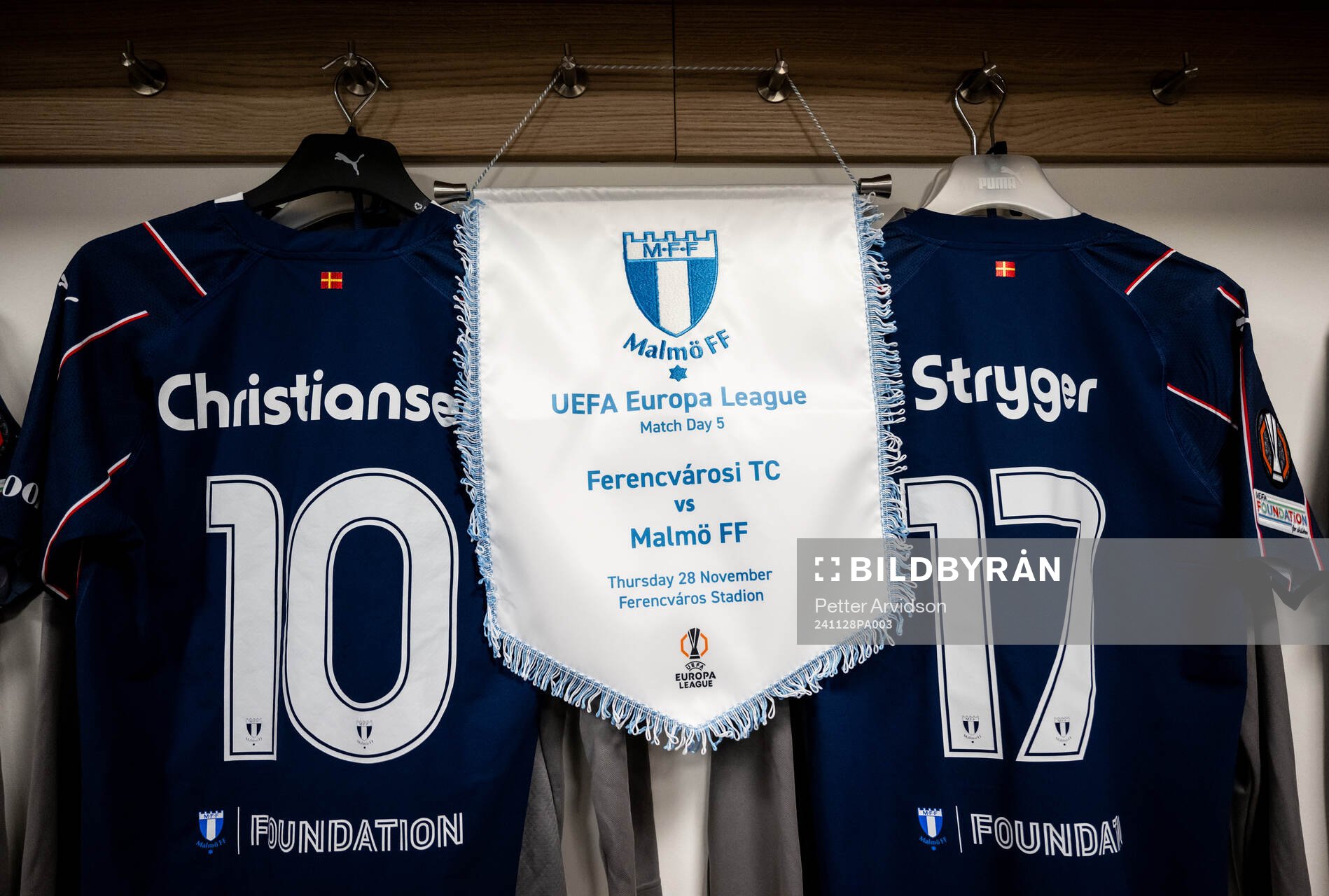 The pennant and the kits of Anders Christiansen and Jens Stryger Larsen of Malmö FF in the dressing room ahead of the UEFA Europa League football match between Ferencvaros and Malmö FF on November 28, 2024 in Budapest.
