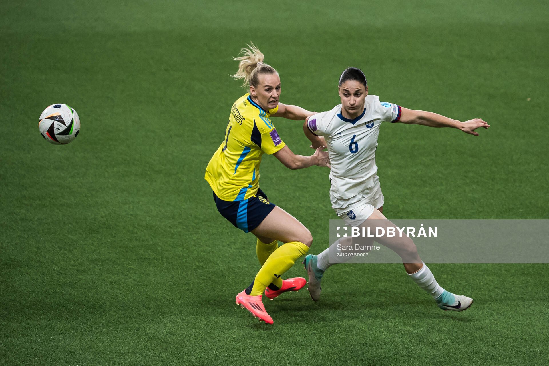 Stina Blackstenius of Sweden and Nevena Damjanovic of Serbia