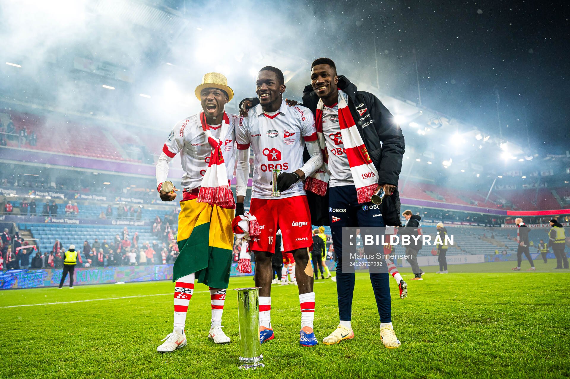 Maxwell Woledzi, Fallou Fall and Mai Traore of Fredrikstad celebrates with the trophy after the cup final match between Fredrikstad and Molde on December 7, 2024 in Oslo.