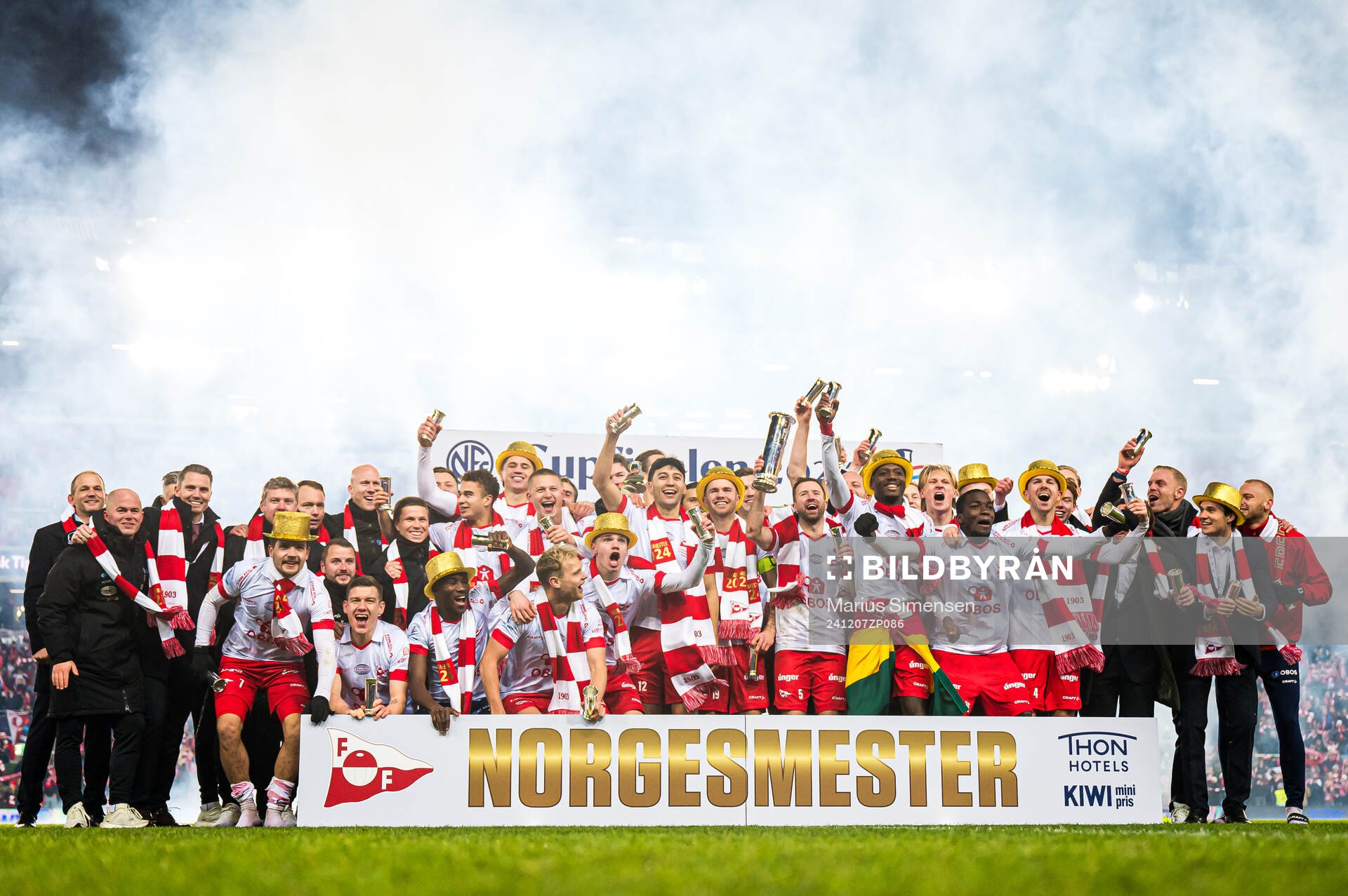 Andreas Hagen, head coach of Fredrikstad, Brandur Hendriksson Olsen, Morten Bjørlo, Maxwell Woledzi, Fallou Fall, Brandur Hendriksson Olsen, Julius Magnusson, Simen Rafn, Sigurd Kvile, Henrik Skogvold of Fredrikstad celebrates with the trophy after the cup final match between Fredrikstad and Molde on December 7, 2024 in Oslo.