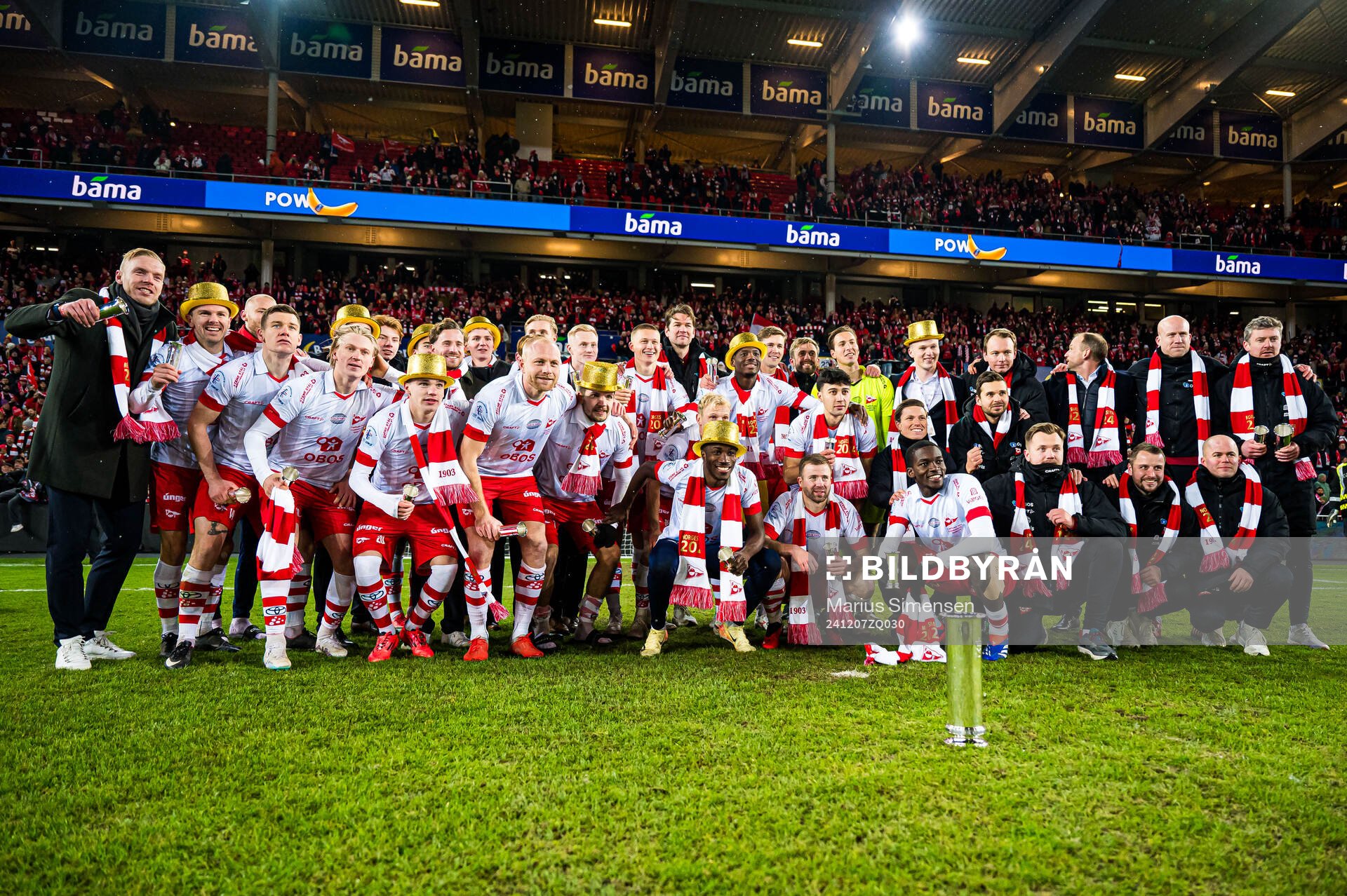 Mads Nielsen, Joannes Bjartalid, Daniel Fritz Eid, Jeppe Kjær Jensen, Henrik Kjelsrud Johansen, Brandur Hendriksson Olsen, Fallou Fall, Simen Rafn, Morten Bjørlo and Andreas Hagen, head coach of Fredrikstad, celebrates with the trophy after the cup final match between Fredrikstad and Molde on December 7, 2024 in Oslo.