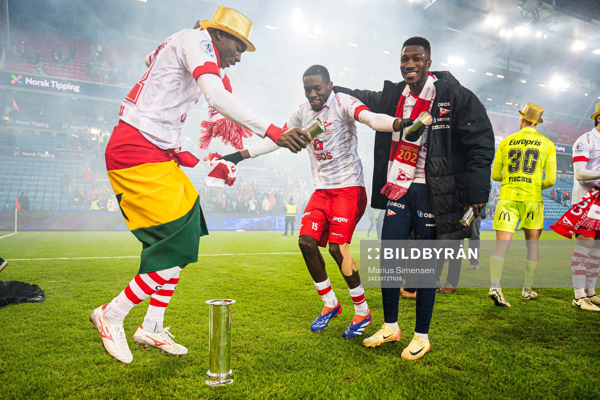 Maxwell Woledzi, Fallou Fall and Mai Traore of Fredrikstad celebrates with the trophy after the cup final match between Fredrikstad and Molde on December 7, 2024 in Oslo.