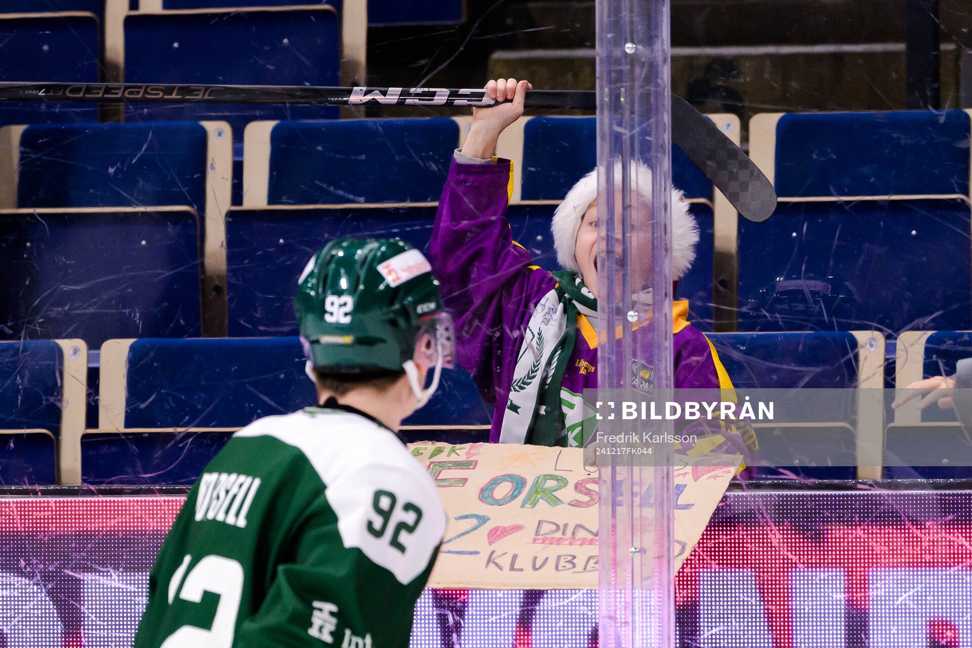 Lucas Forsell of Färjestad  gives his stick to a kid