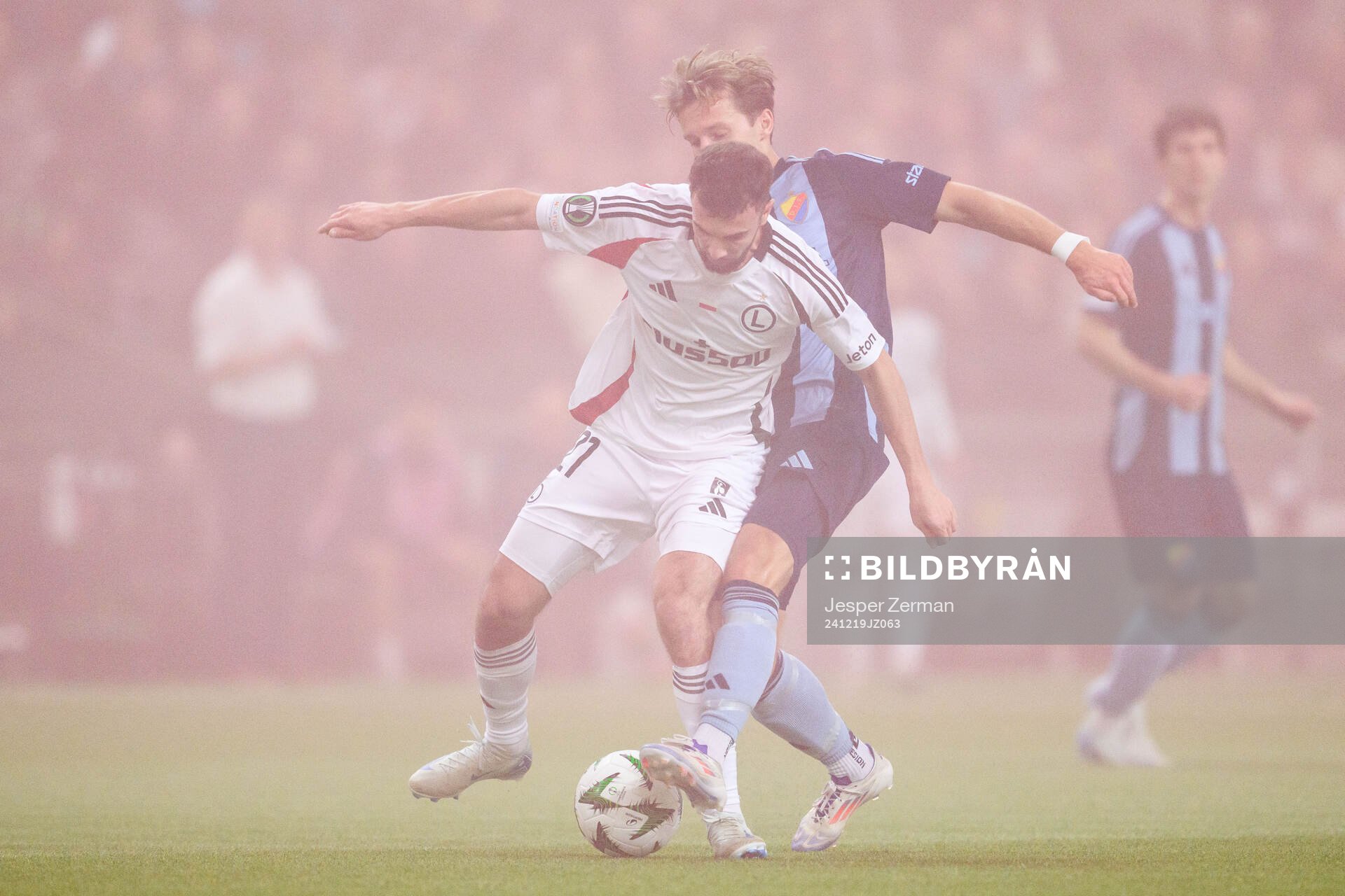 Jurgen Celhaka of Legia Warszawa and Daniel Stensson of Djurgården during the UEFA Conference League match between Djurgården and Legia Warszawa on December 19, 2024 in Stockholm.