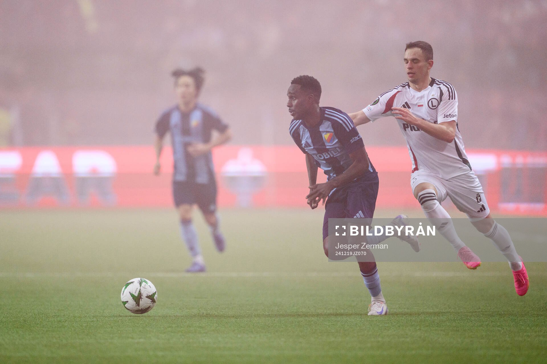 Tokmac Nguen of Djurgården and Kacper Chodyna of Legia Warszawa during the UEFA Conference League match between Djurgården and Legia Warszawa on December 19, 2024 in Stockholm.