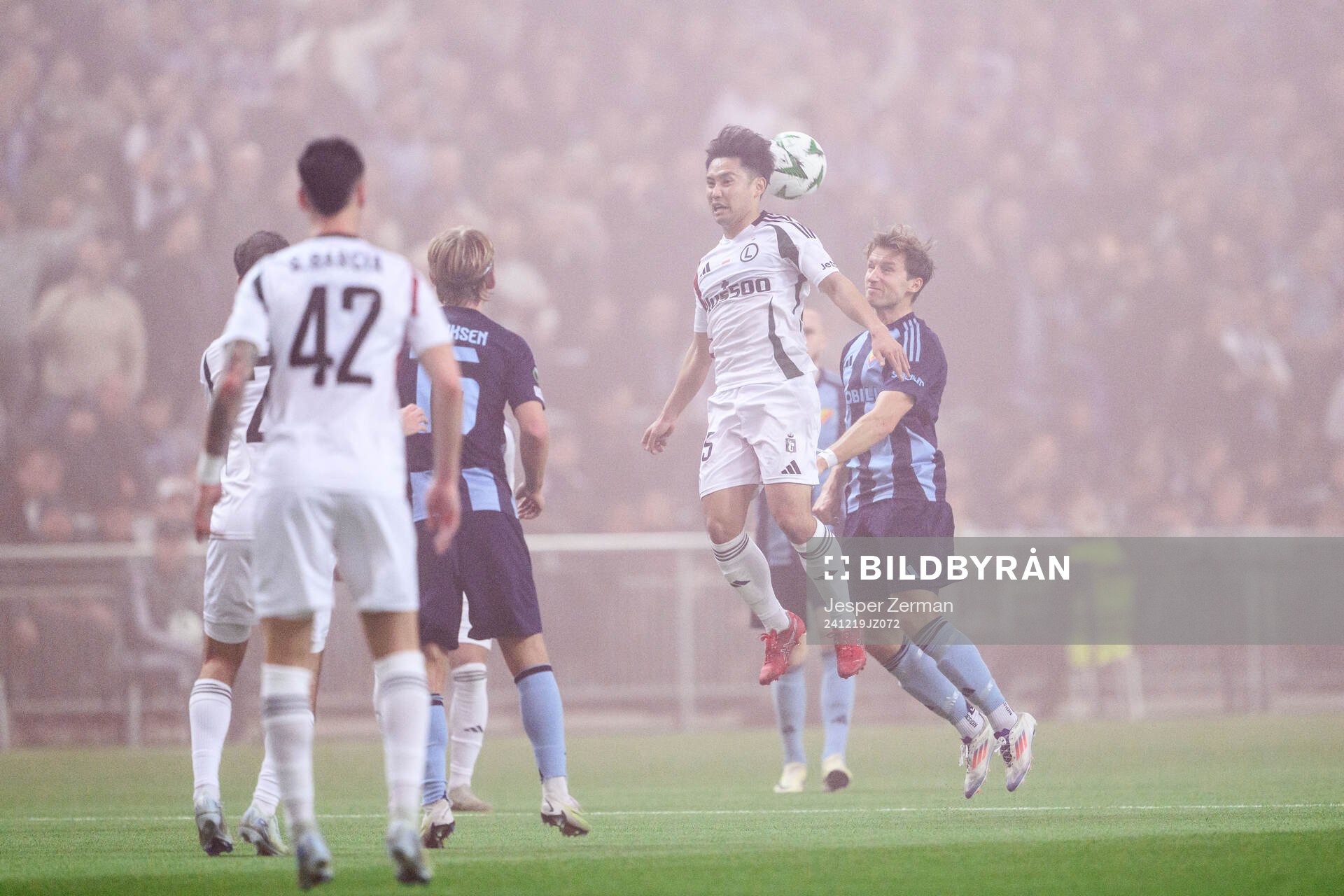 Ryoya Morishita of Legia Warszawa and Daniel Stensson of Djurgården during the UEFA Conference League match between Djurgården and Legia Warszawa on December 19, 2024 in Stockholm.