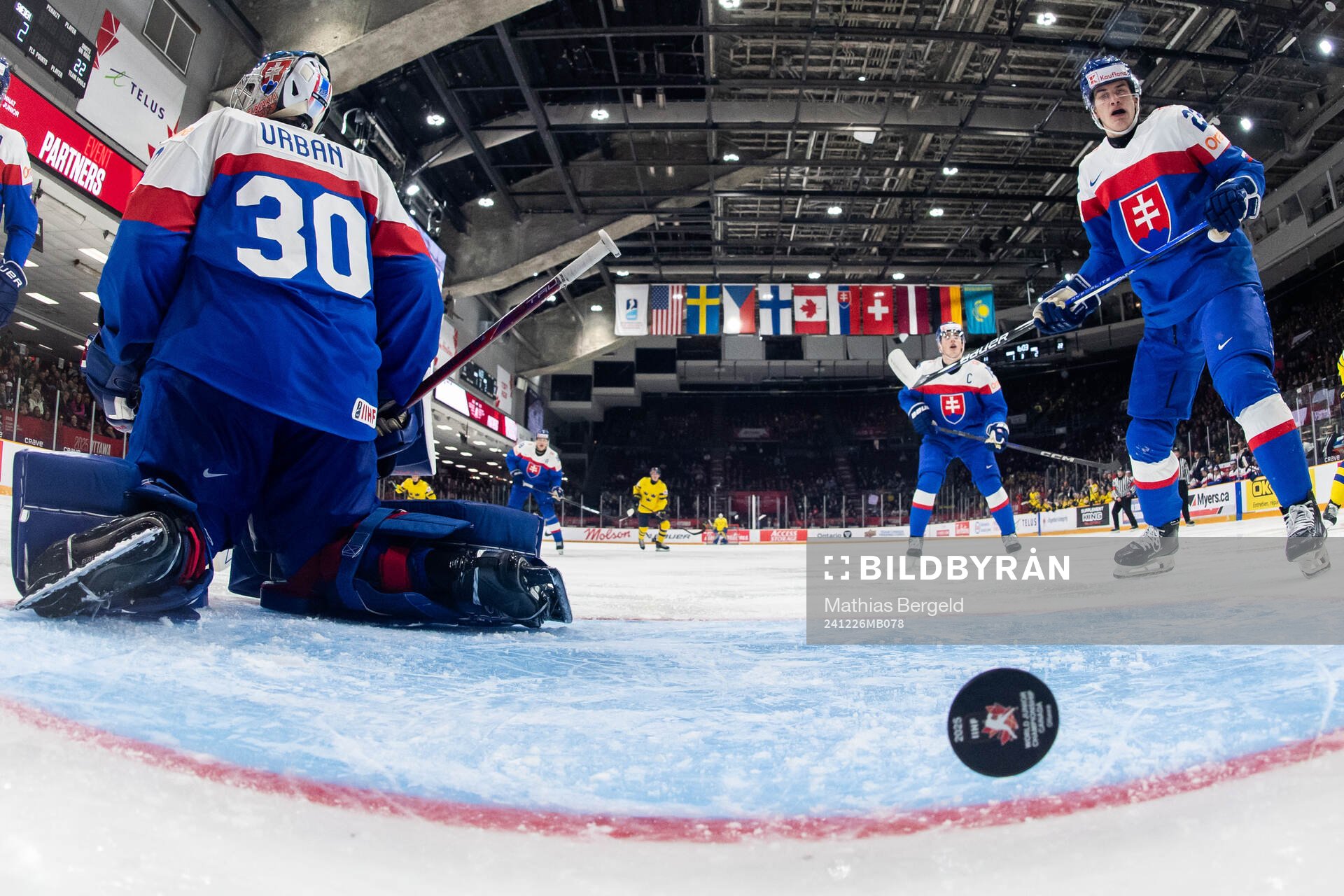Goaltender Samuel Urban and Samuel Barcik of Slovakia look