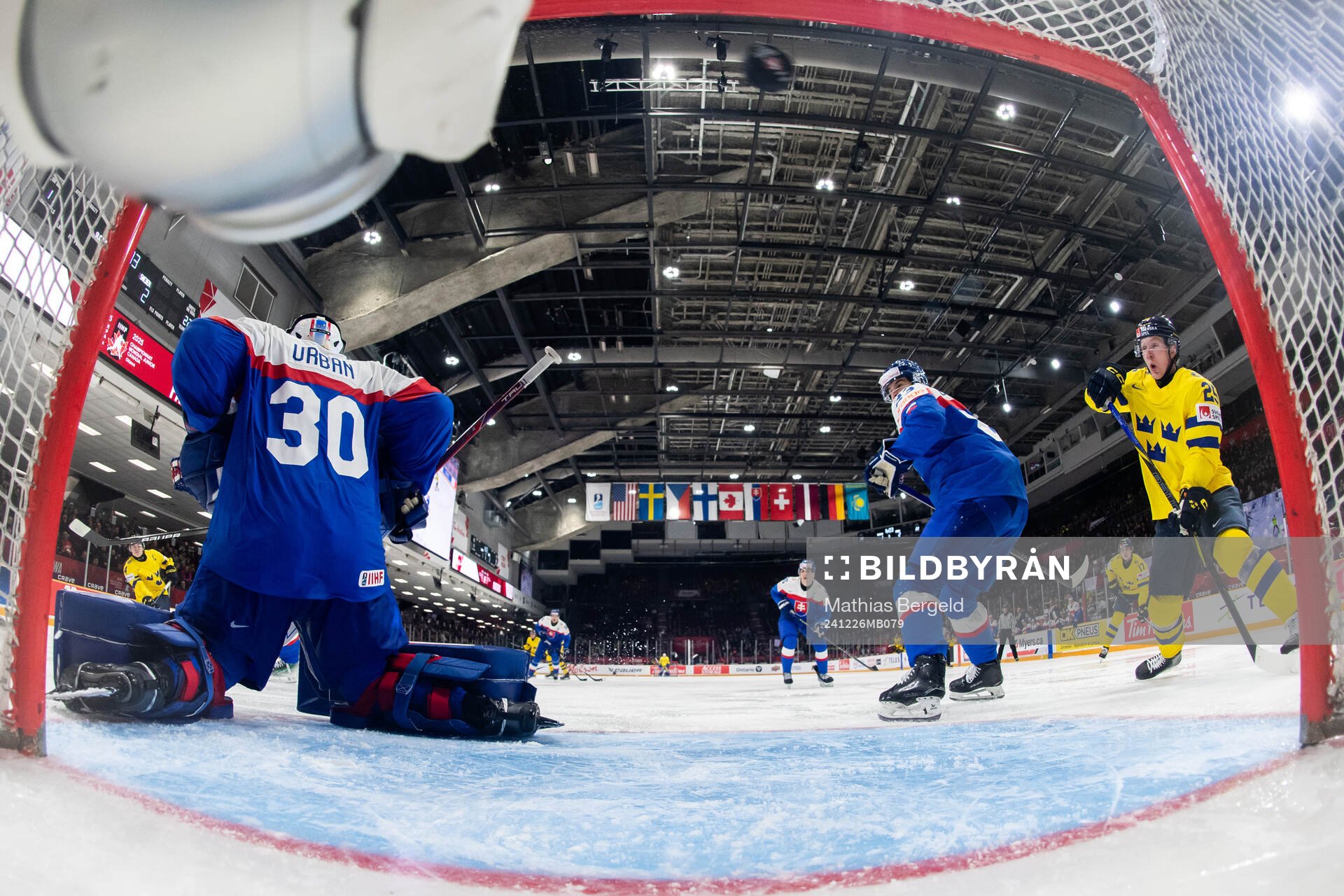 Axel Sandin-Pellikka of Sweden scores 1-3 behind goaltender