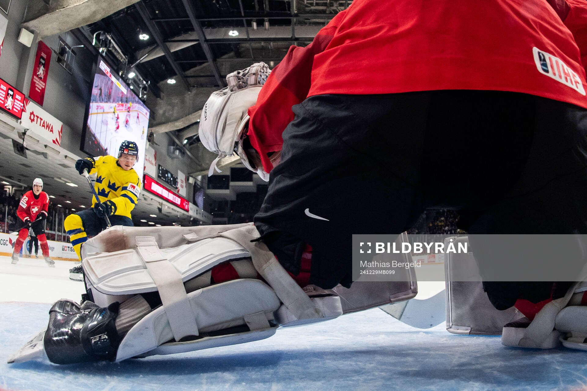 Zeb Forsfjäll of Sweden scores 1-2 behind goaltender