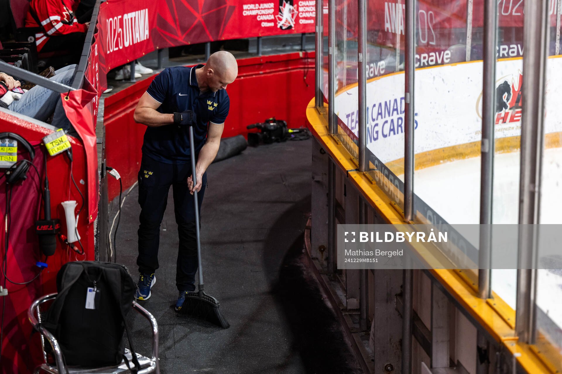 Equipment manager Jonas Landström sweeps the floor