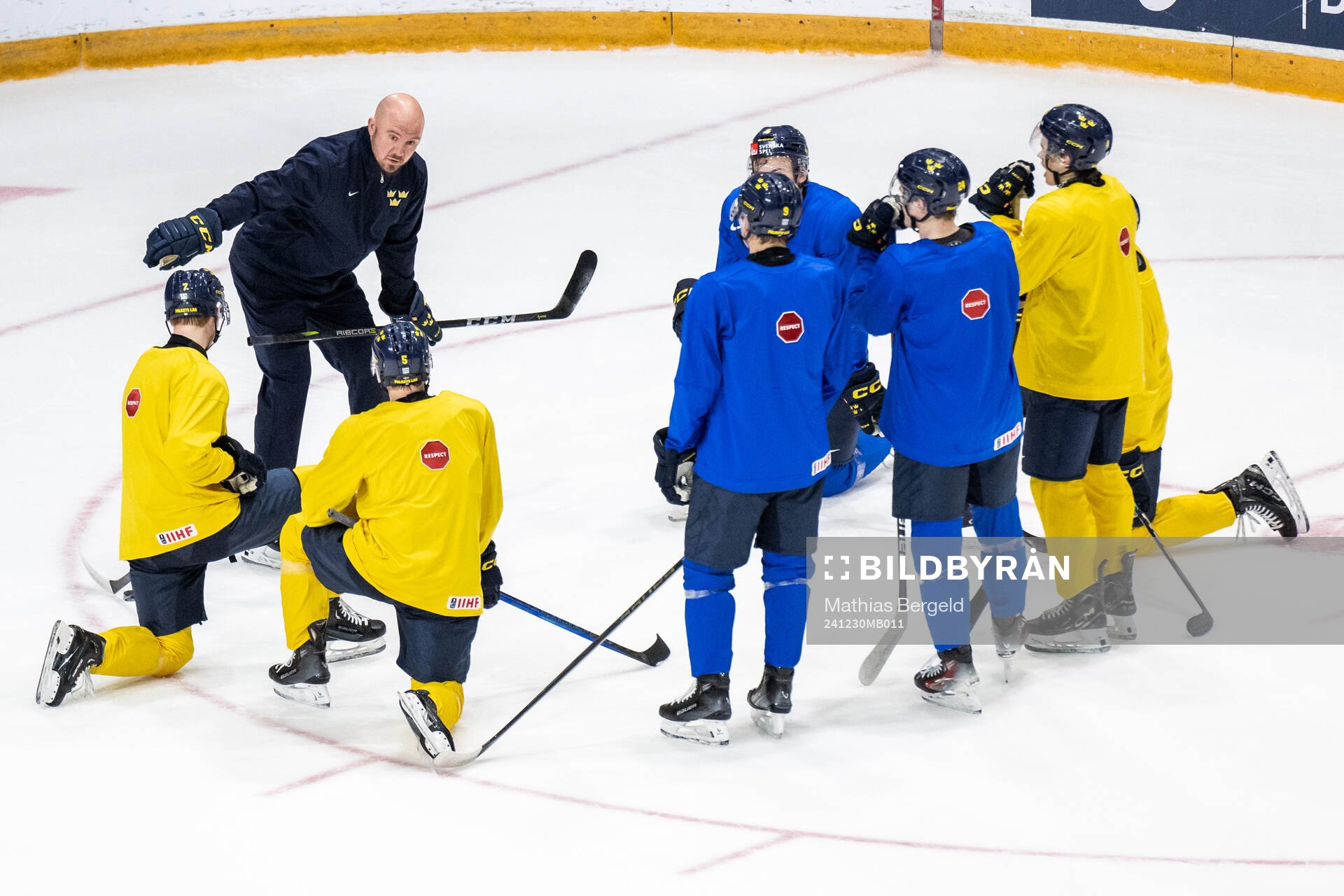 Assistant coach Nicklas Grossmann of Sweden talks to