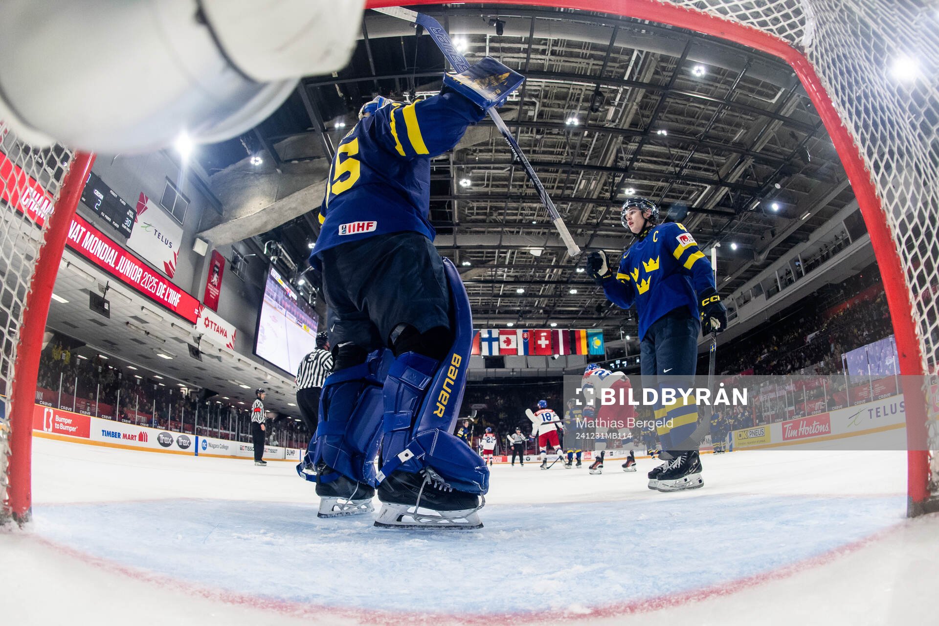 Goaltender Melker Thelin of Sweden celebrates with Axel