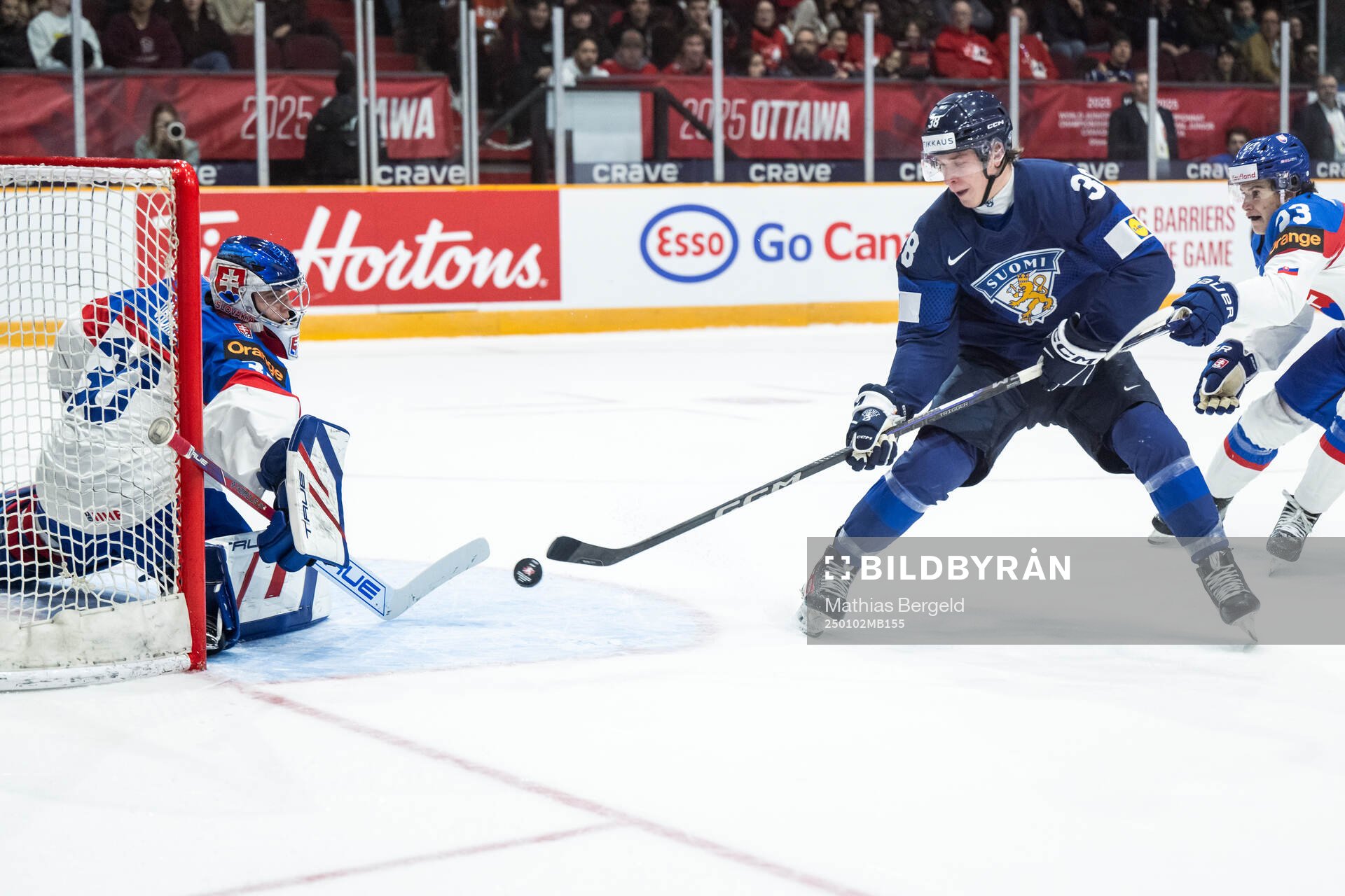 Goaltender Samuel Urban of Slovakia and Jesse Kiiskinen of