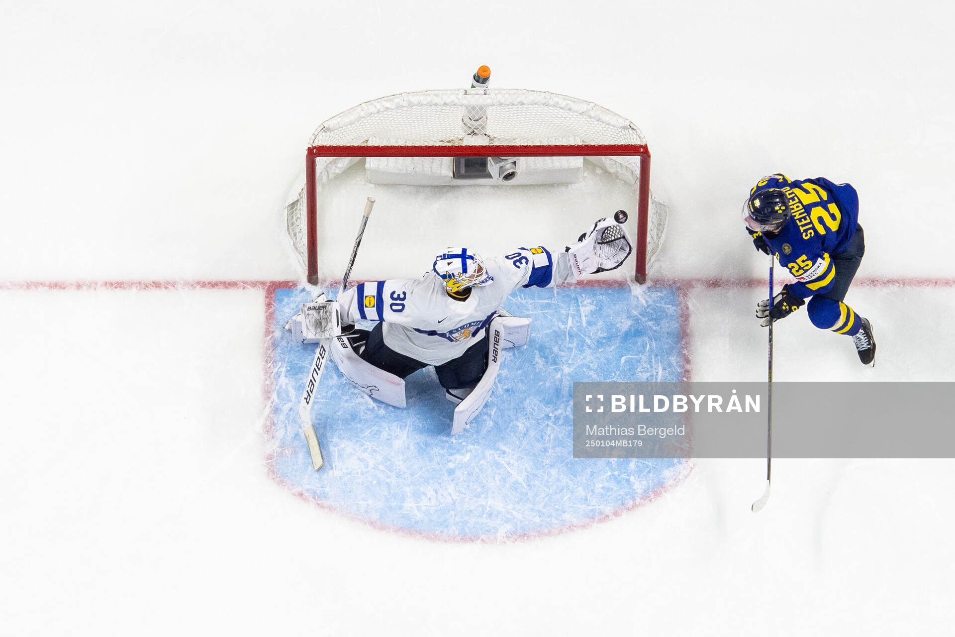 Goaltender Petteri Rimpinen of Finland with a save next to