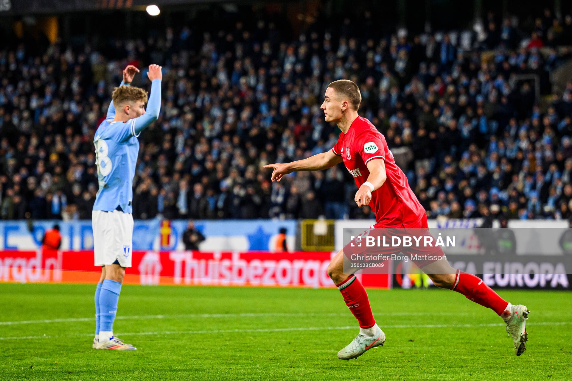 Hugo Bolin of Malmö FF looks dejected and Gustaf Lagerbielke of Twente celebrates after 3-1 during the UEFA Europa League football match between Malmö FF and Twente on January 23, 2025 in Malmö.