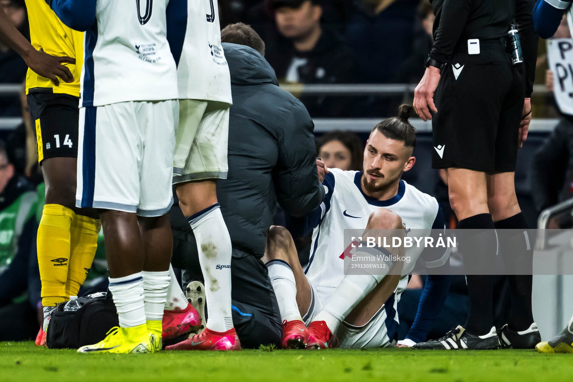 Radu Dragusin of Tottenham Hotspur in pain