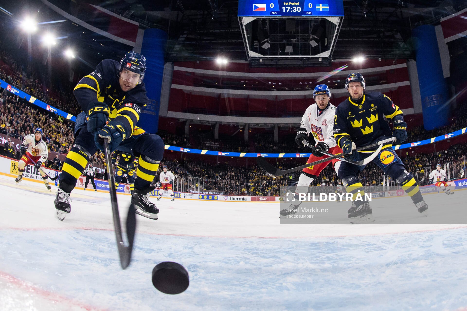 Henrik Tömmernes of Sweden stretches for the puck as Tim