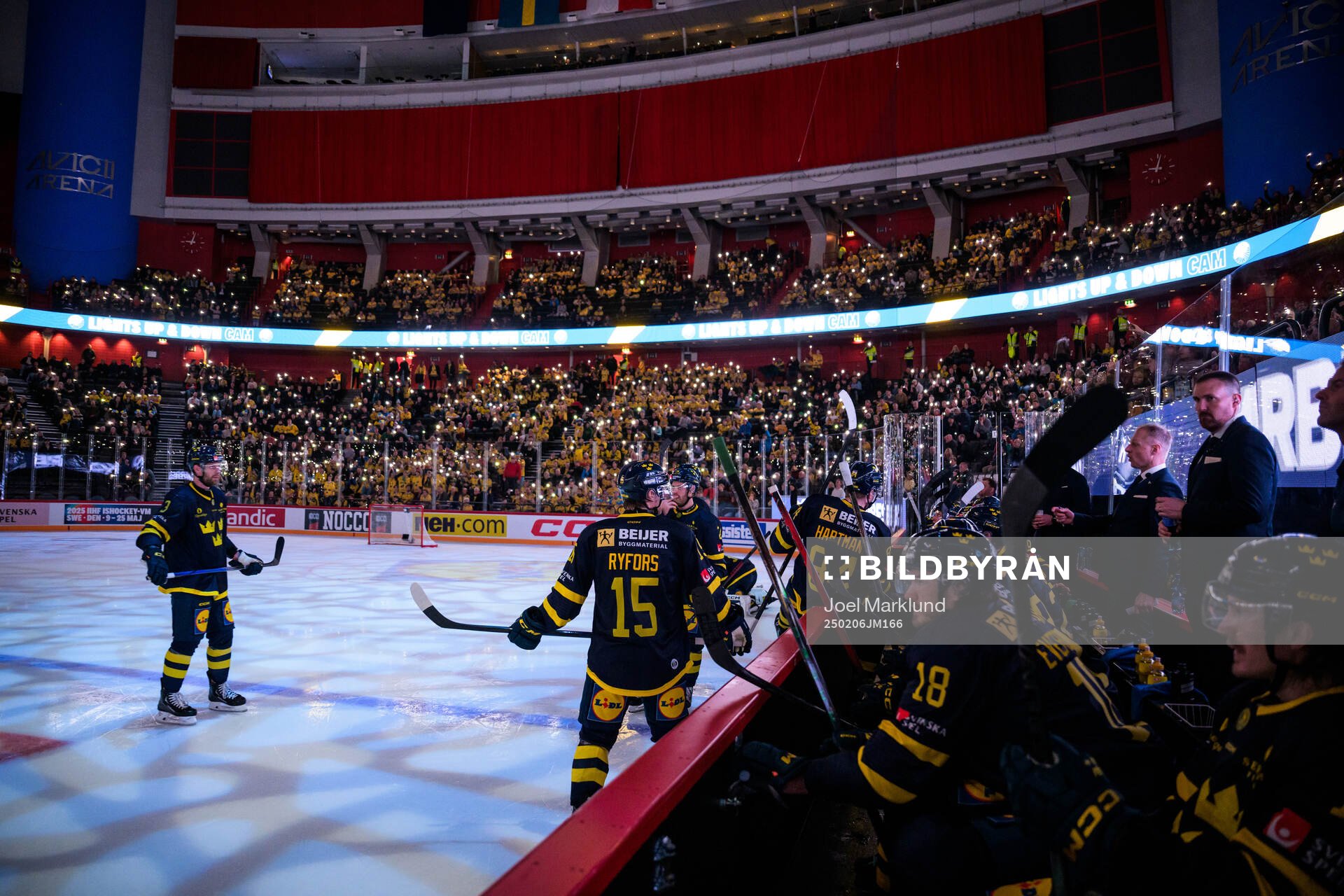 Swedish players in front of spectators illuminating the