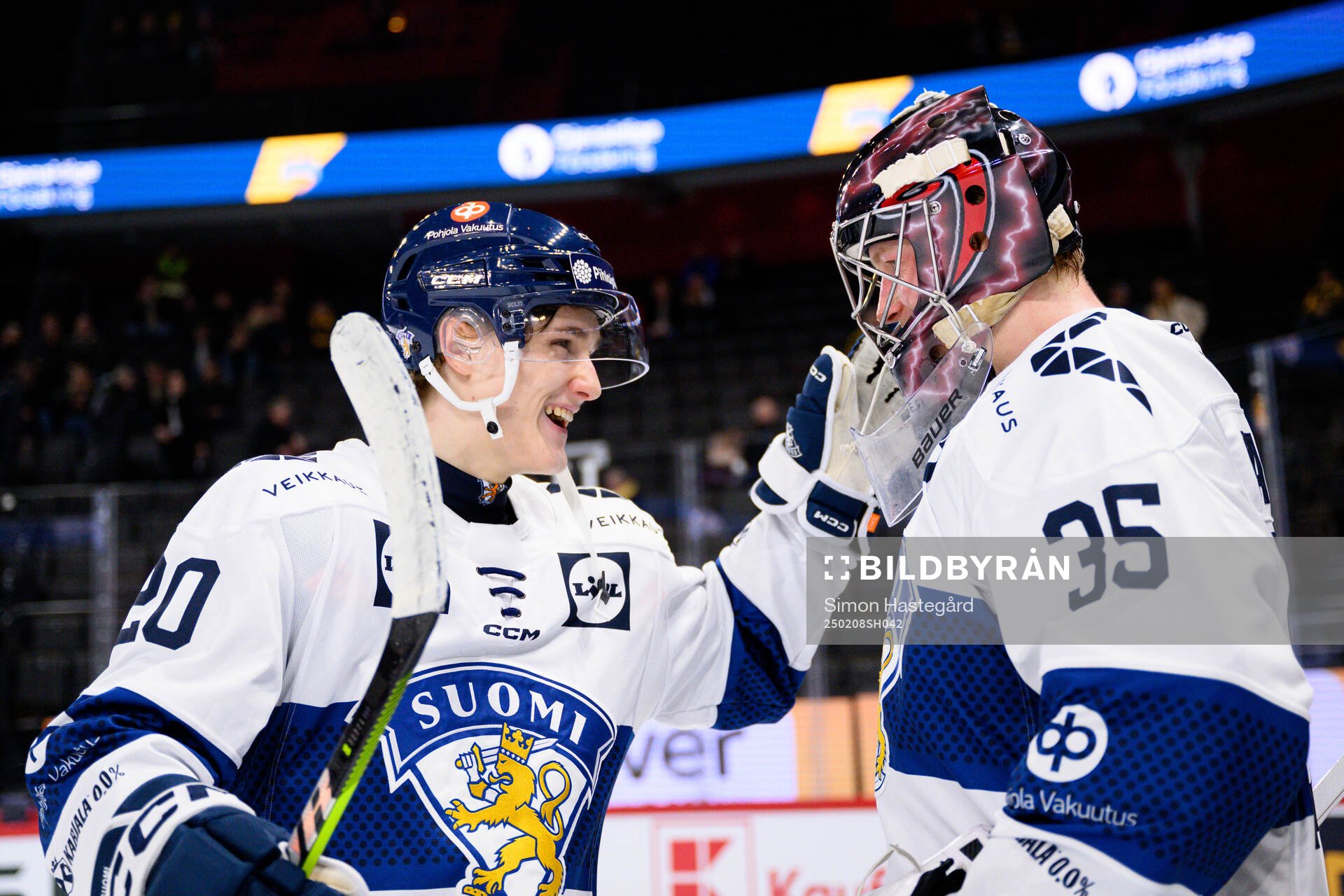 Oiva Keskinen and goalkeeper Oskari Salminen of Finland
