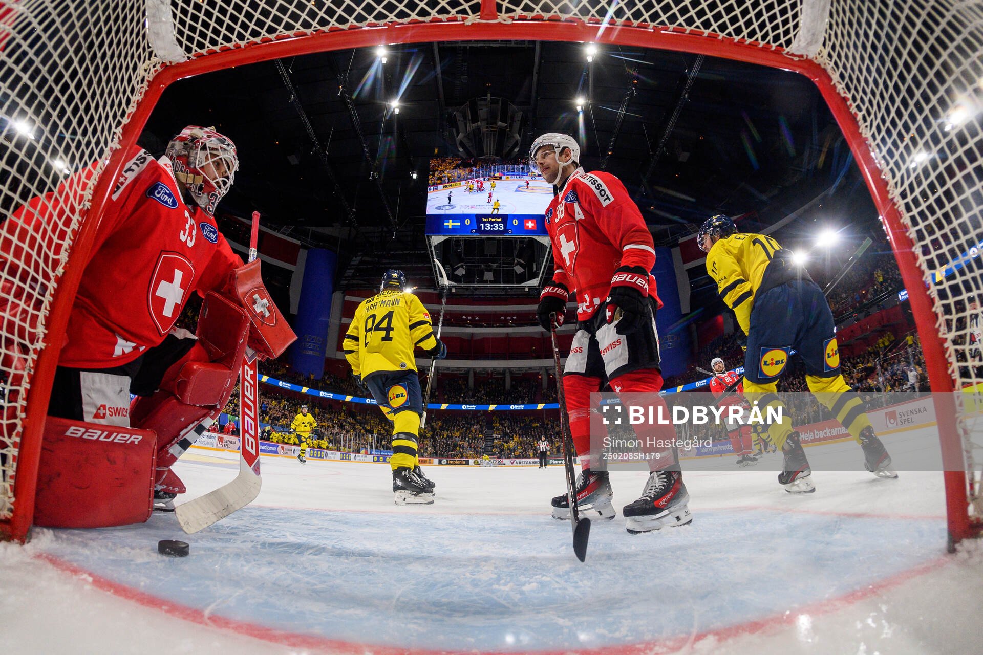 Goaltender Kevin Pasche and Lukas Frick of Switzerland look