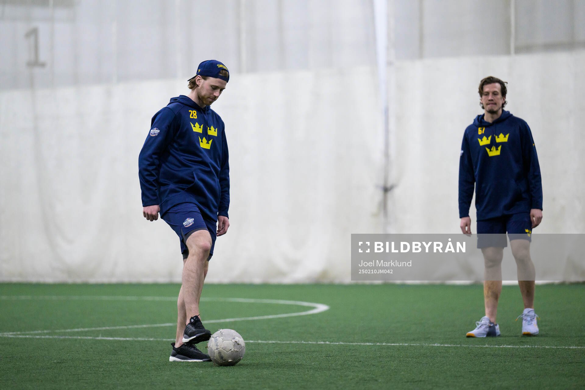 Elias Lindholm and Rickard Rakell of Sweden playing football