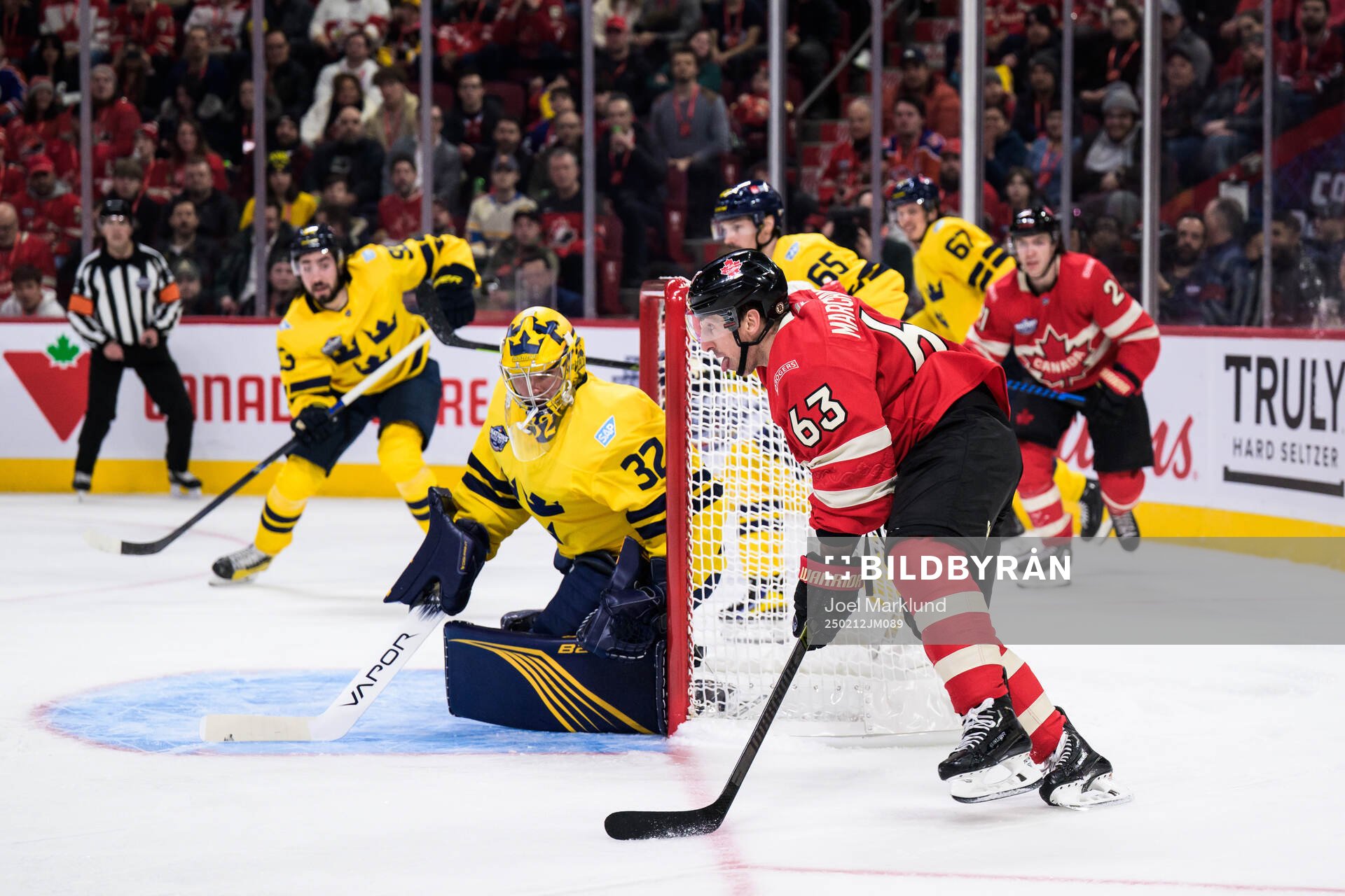 Goaltender Filip Gustavsson of Sweden is being challenged