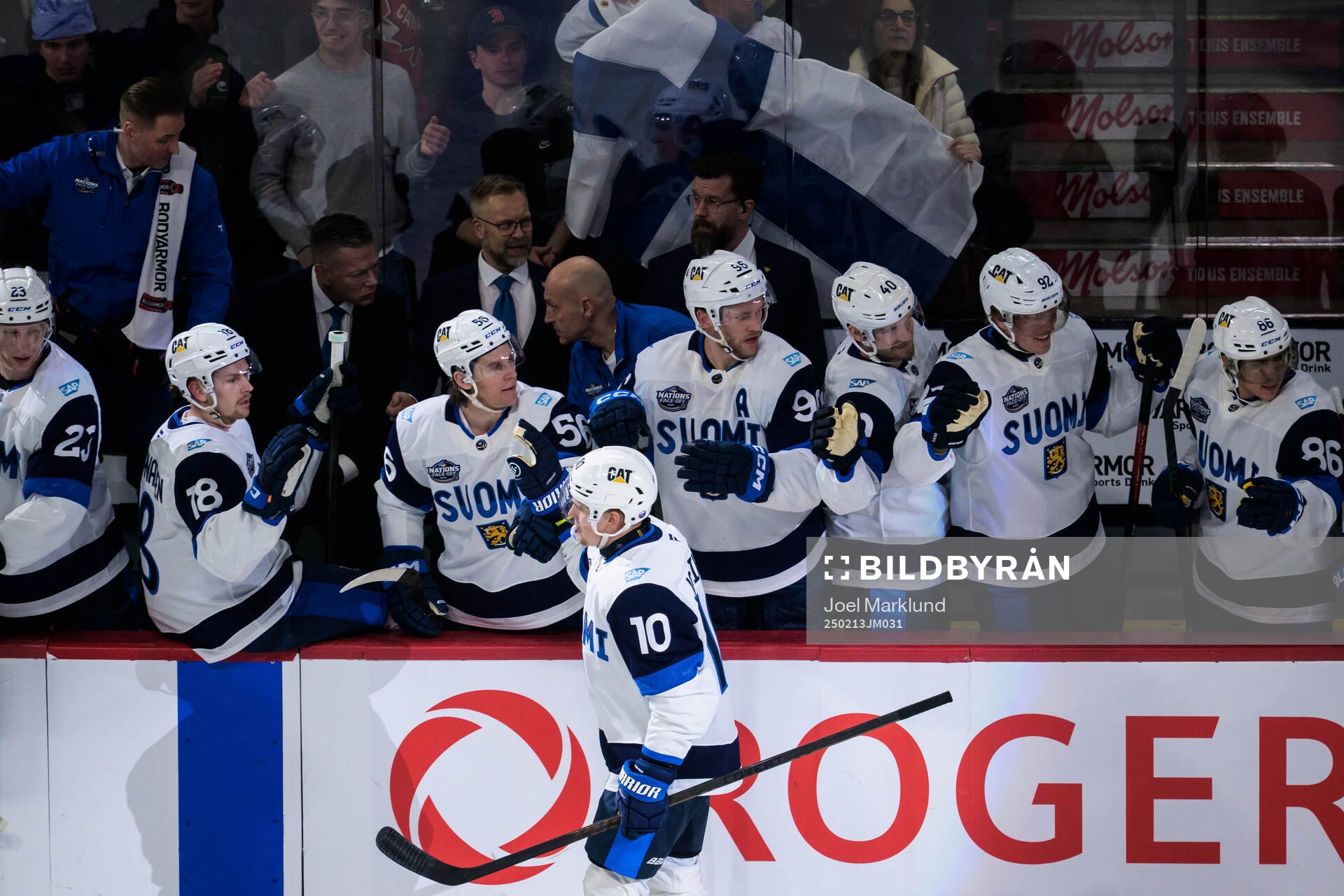 Henri Jokiharju of Finland celebrates with teammates