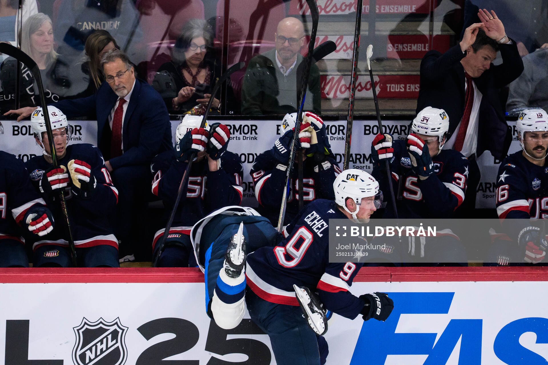 Jack Eichel of USA tackles Aleksander Barkov of Finland