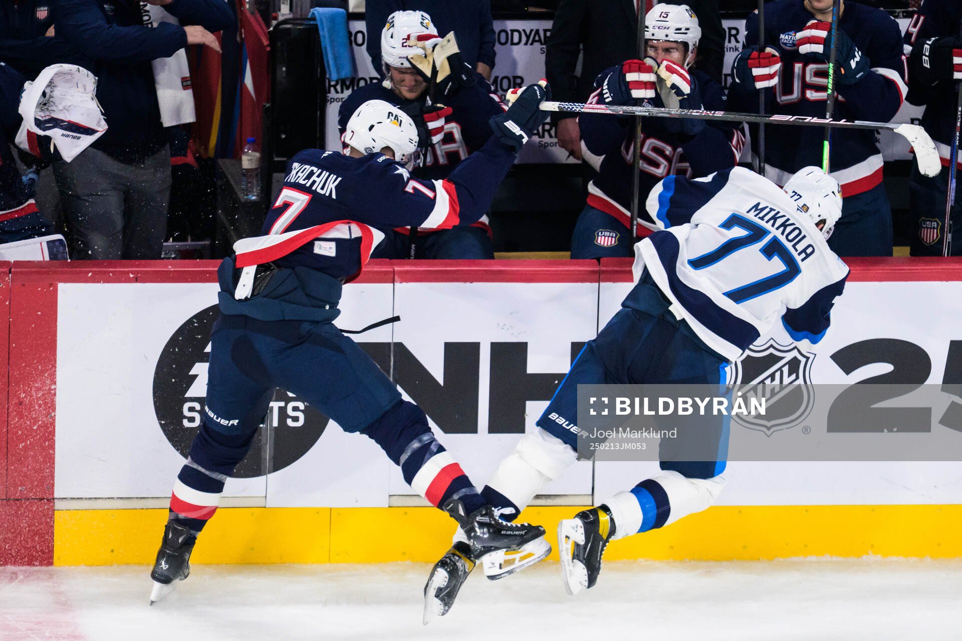 Brady Tkachuk of USA tackles Niko Mikkola of Finland