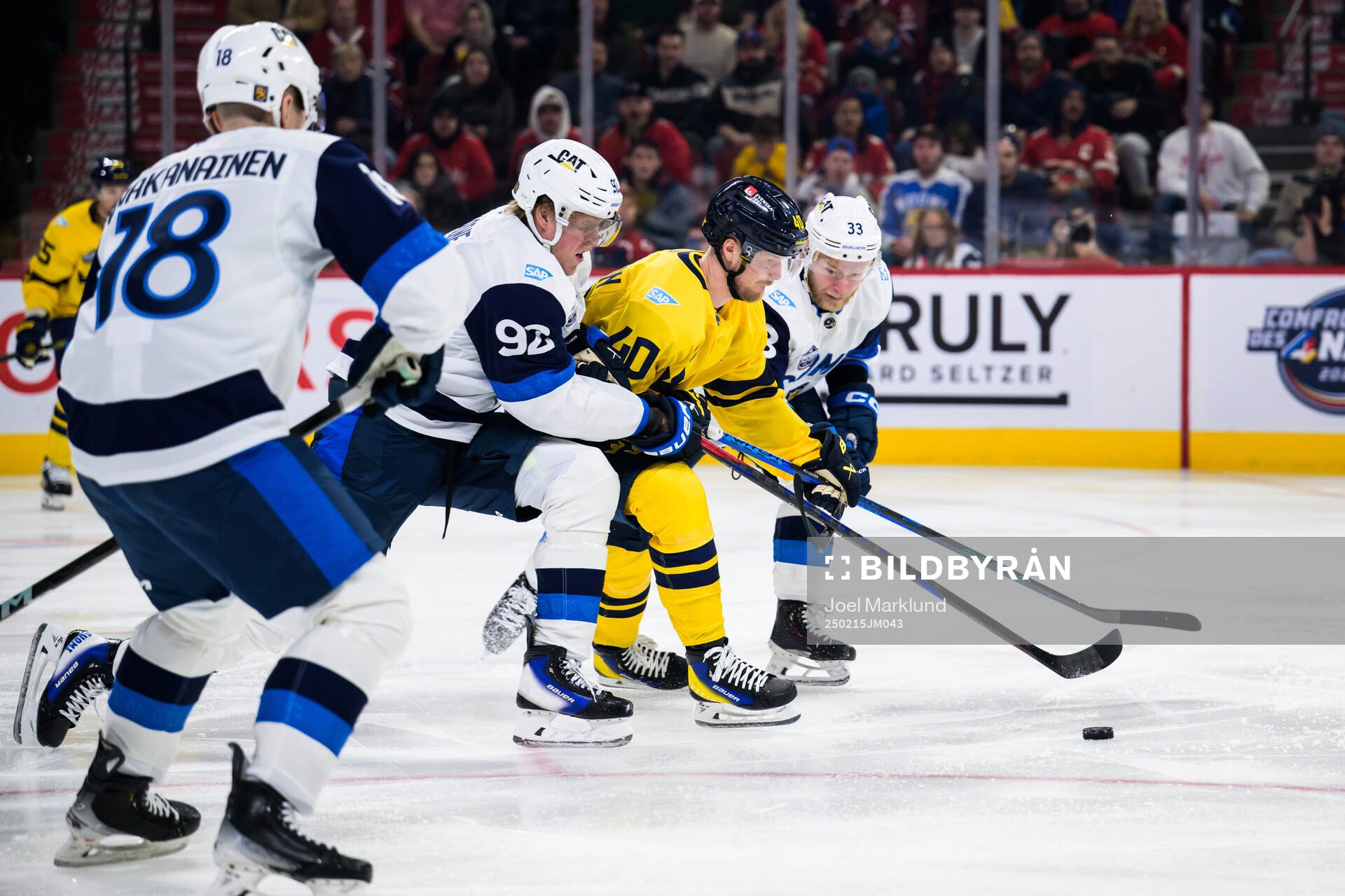 Patrik Laine and Nikolas Matinpalo of Finland are being