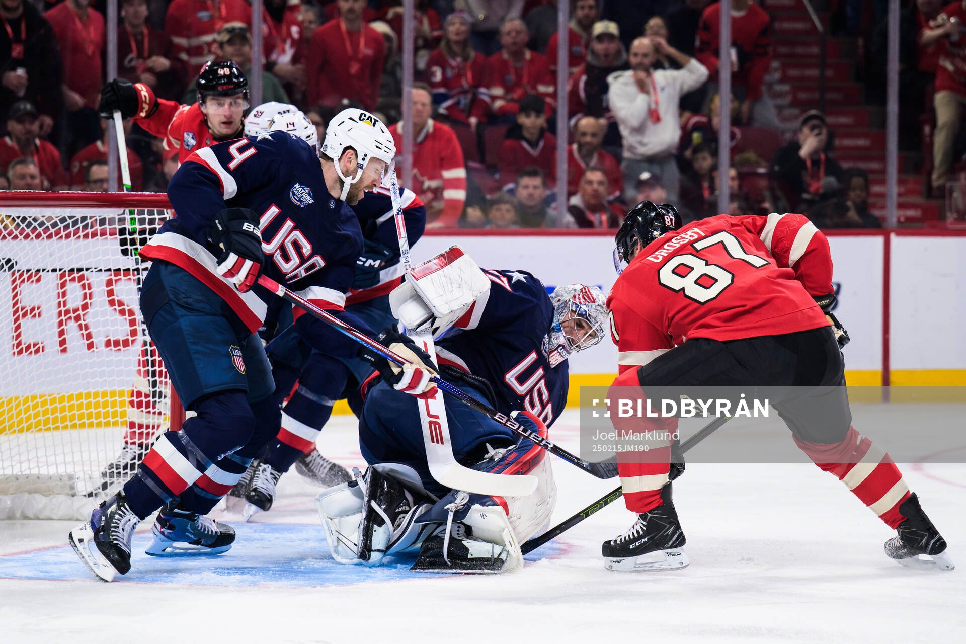 Jaccob Slavin and goaltender Connor Hellebuyck of USA are
