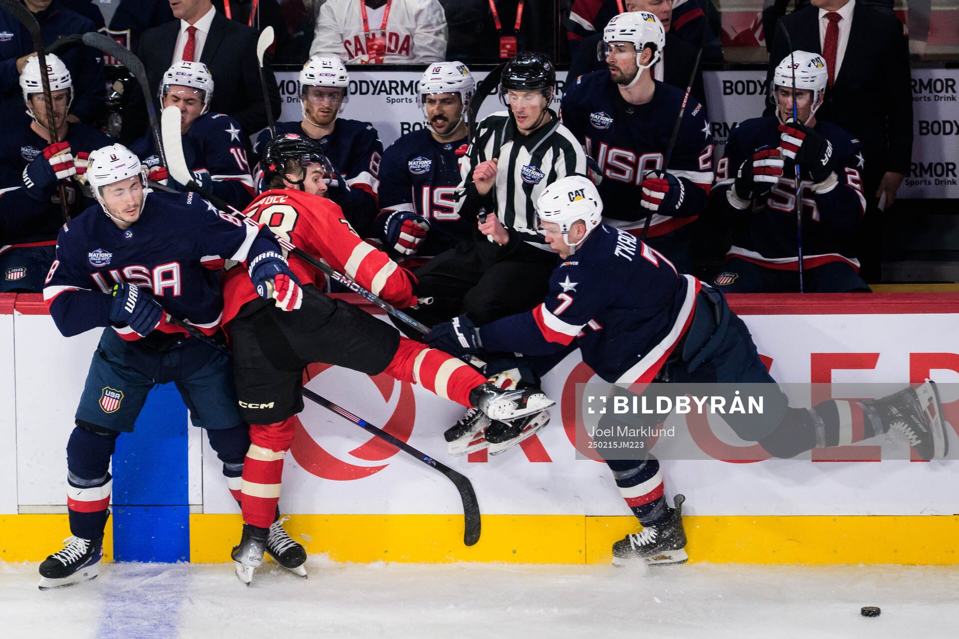 Zach Werenski and Brady Tkachuk of USA are being challenged