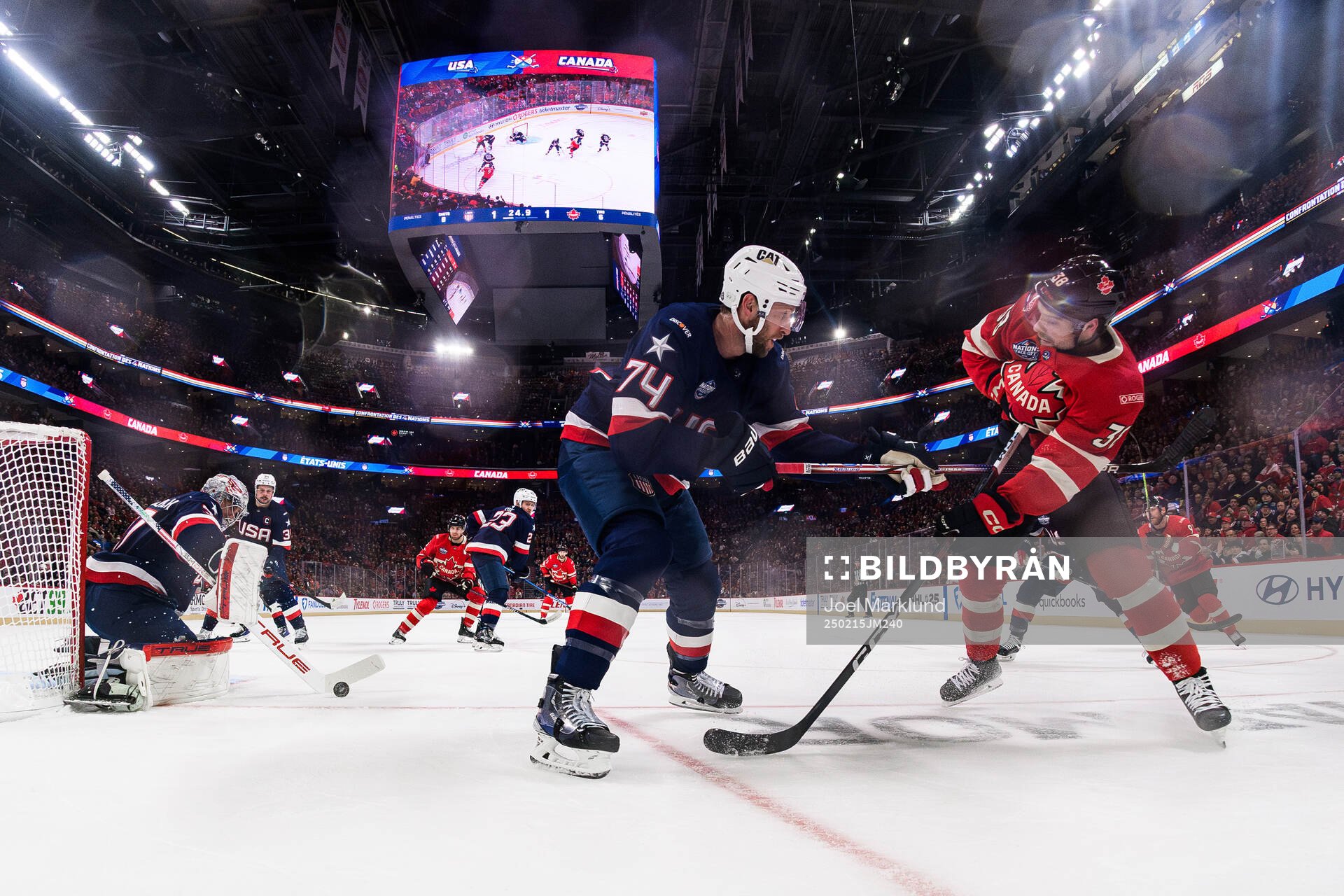 Goaltender Connor Hellebuyck and Jaccob Slavin of USA and