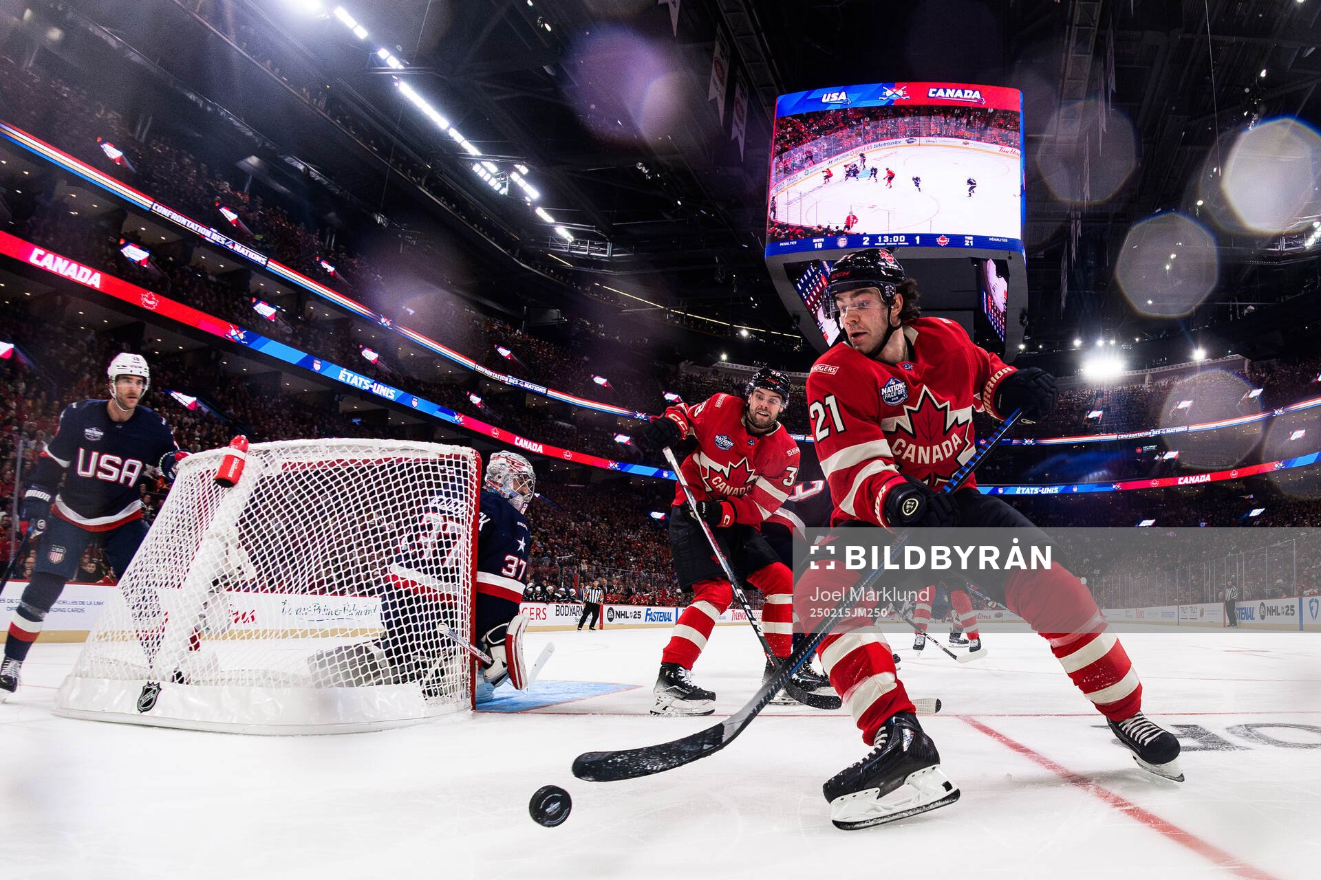 Goaltender Connor Hellebuyck of USA is being challenged by
